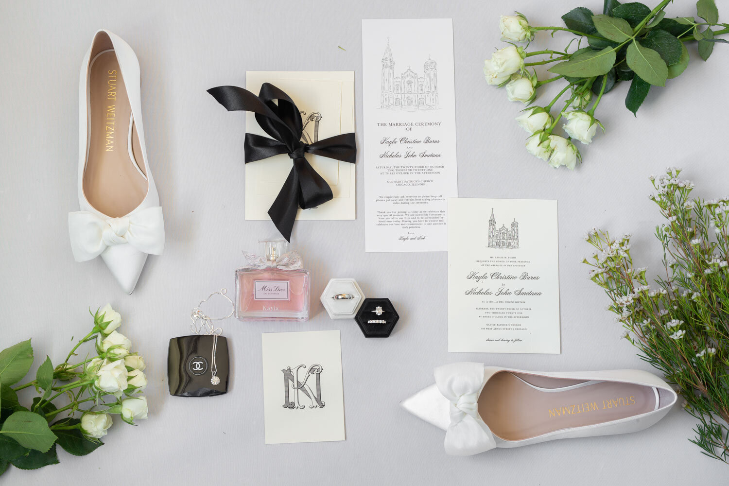 Flat lay of wedding invitation and details