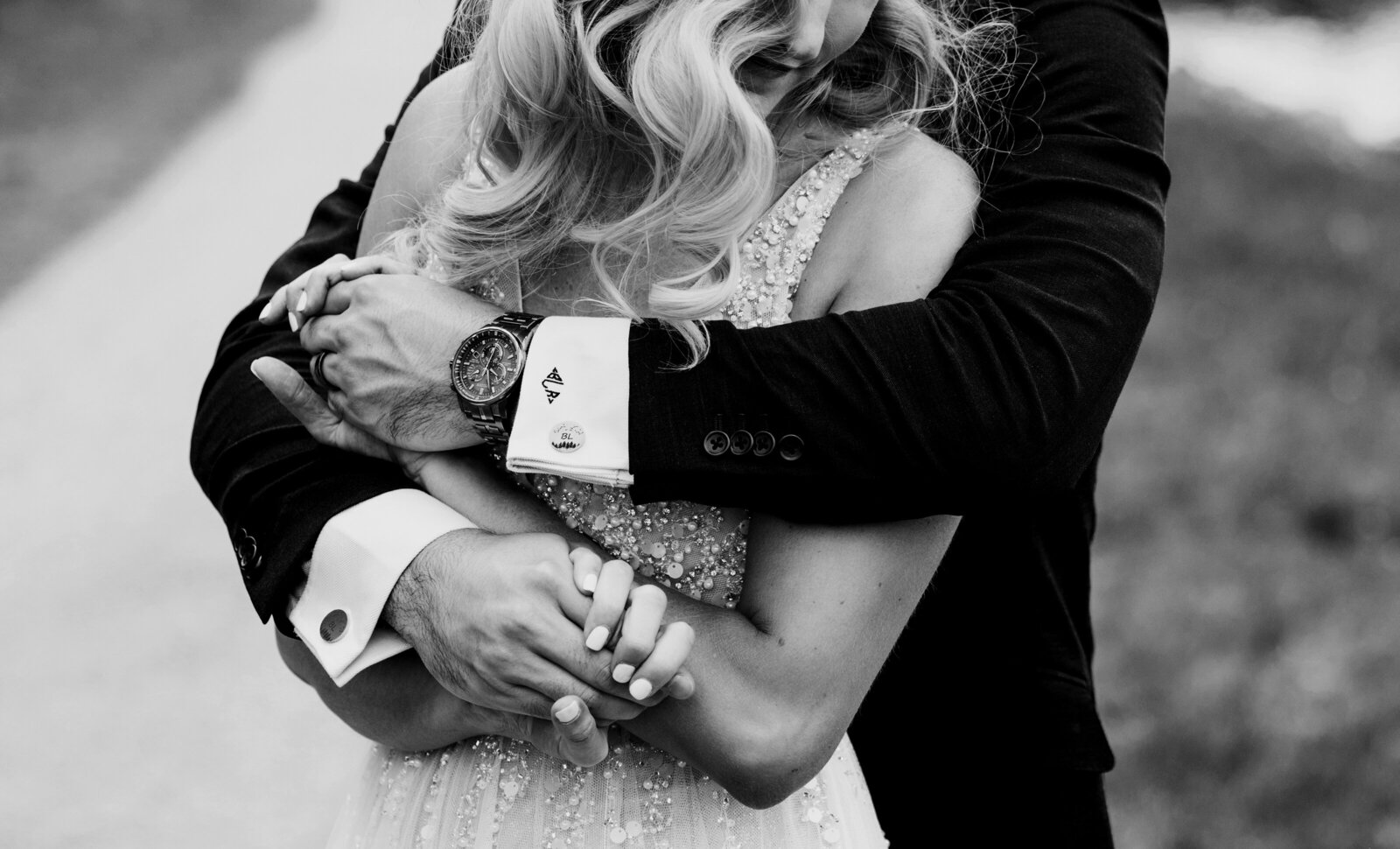 A close-up black-and-white image of a bride and groom embracing in Canmore, Alberta