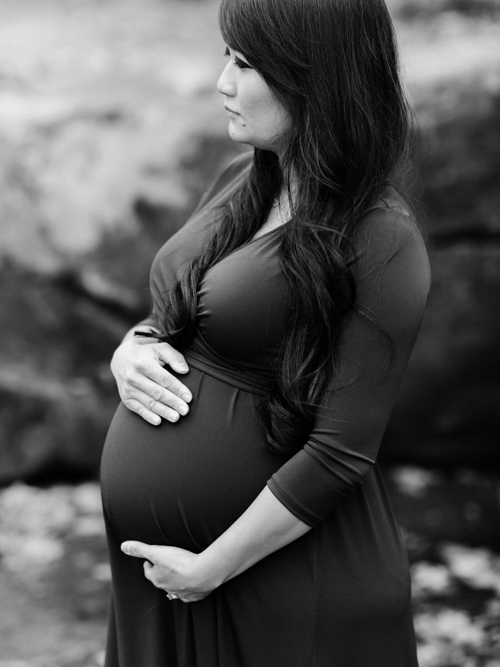 pregnant woman holding belly for photoshoot