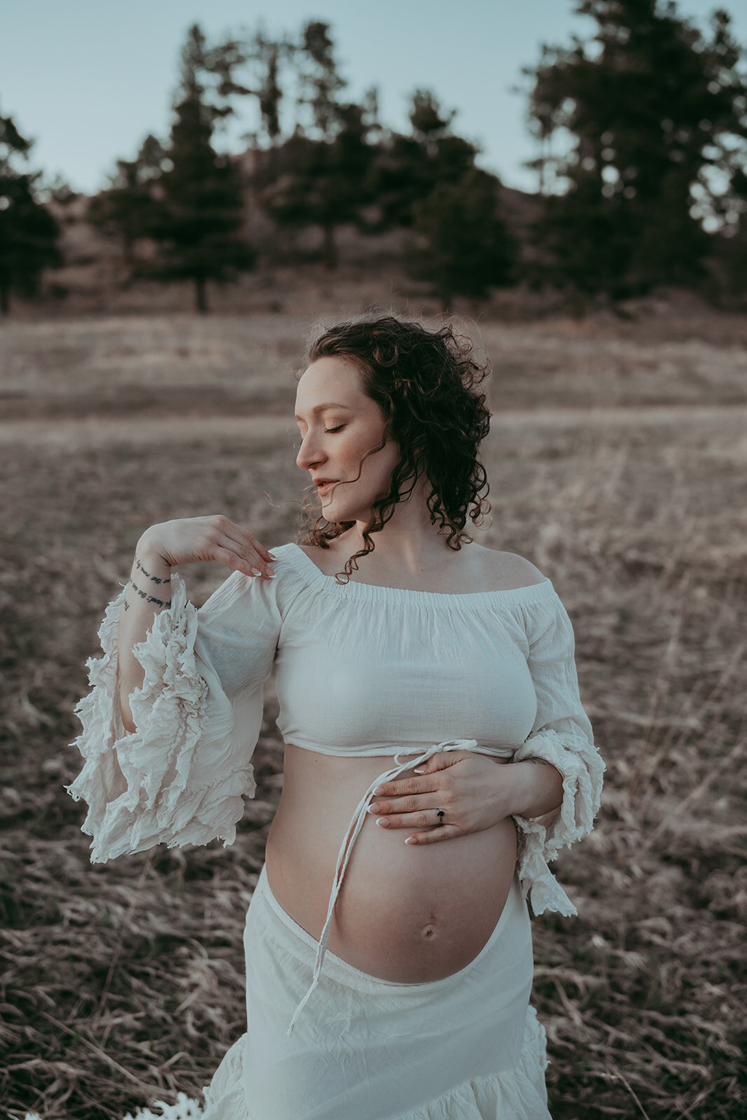 expectant mom poses in Boho Shed dress