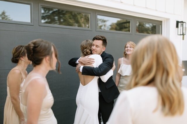 Bride and brother hug during prayer circle before Vancouver, WA wedding ceremony