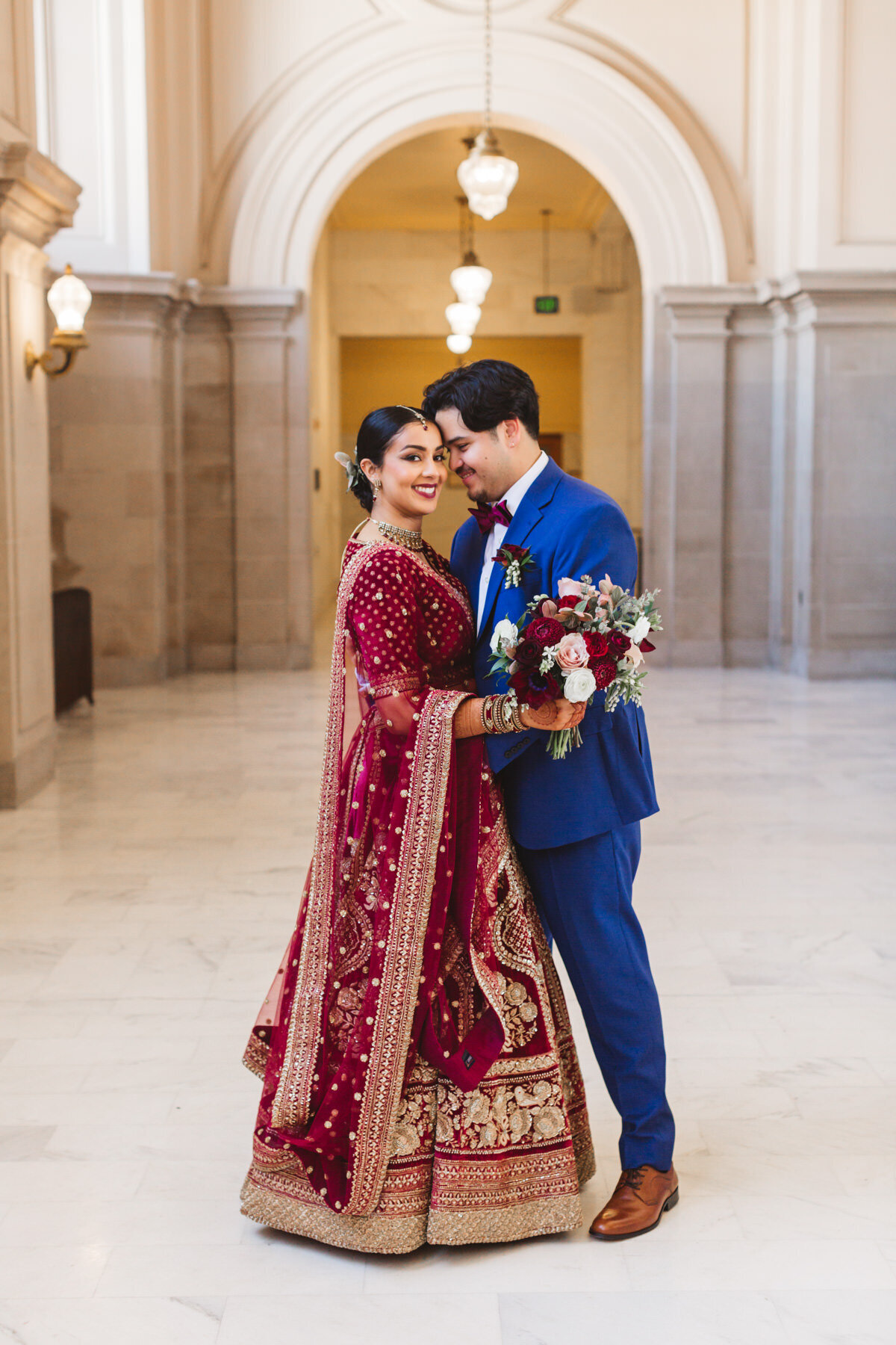 Indian wedding couple with bride in red wedding dress
