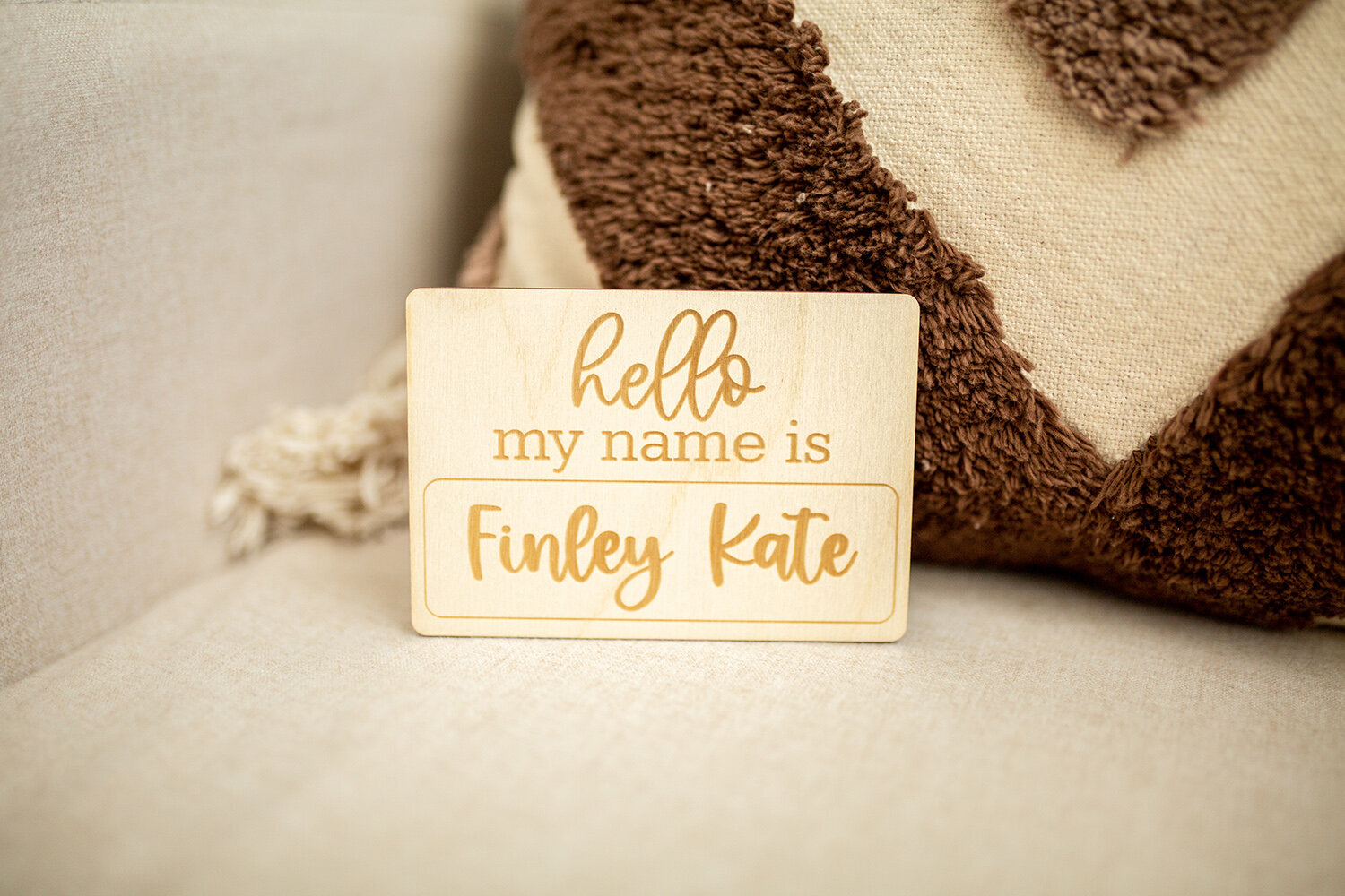 wooden name card on bed