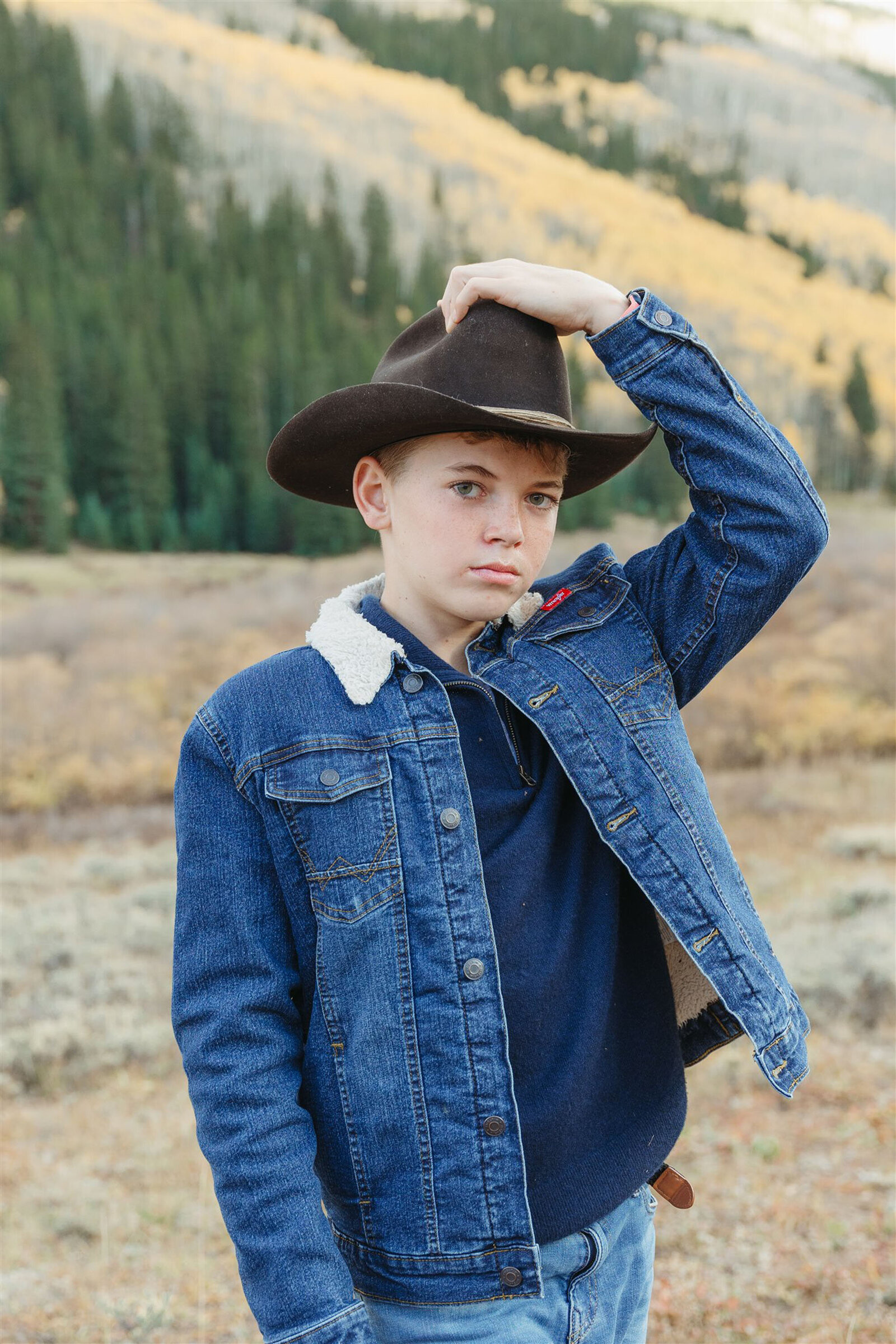 Aspen family photography with a Ralph Lauren aesthetic — navy, camel, and cream tones against alpine greens in the Roaring Fork Valley.
