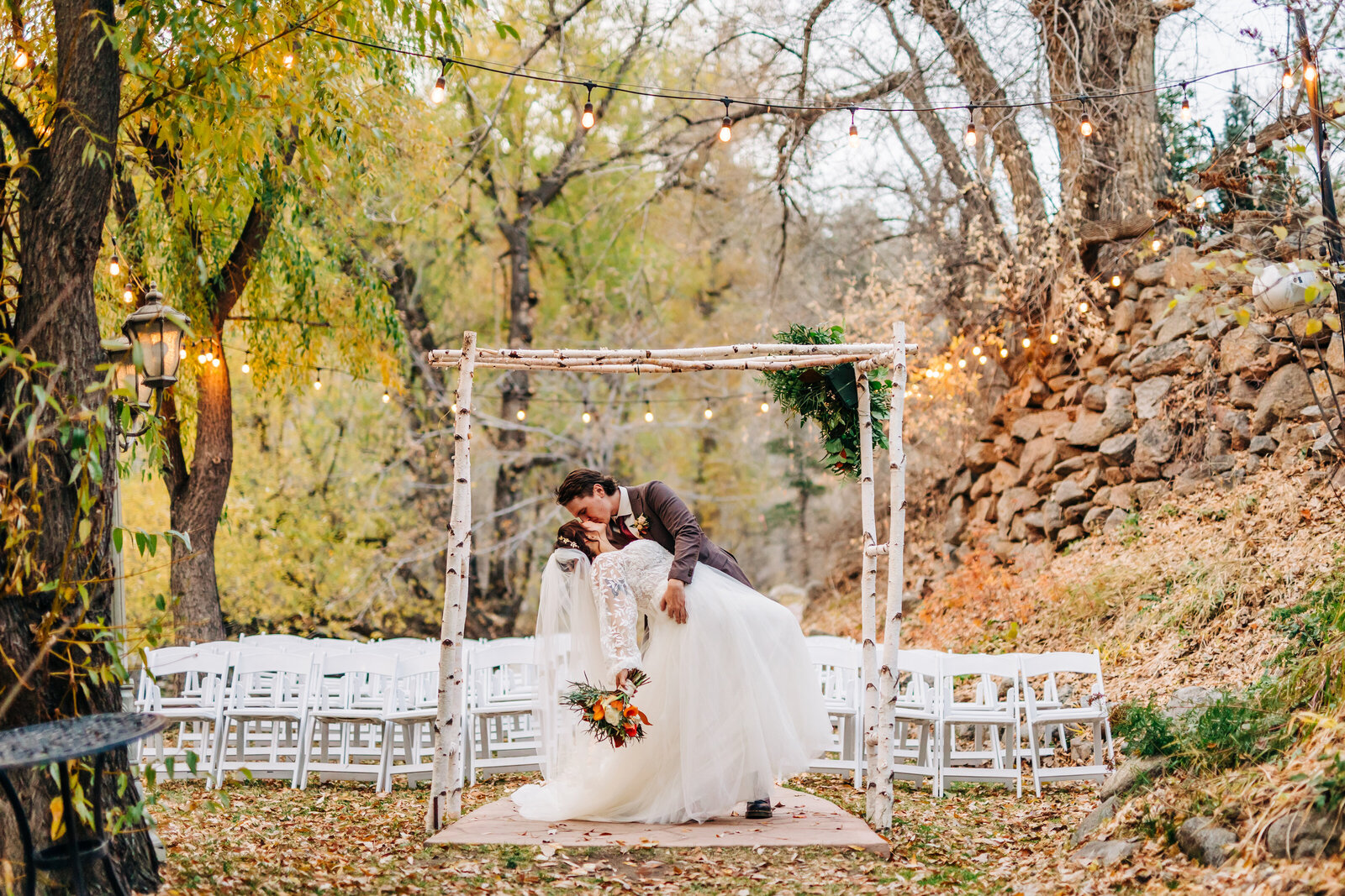Denver Wedding Photographer captures bride and groom dip kiss after fall forest wedding