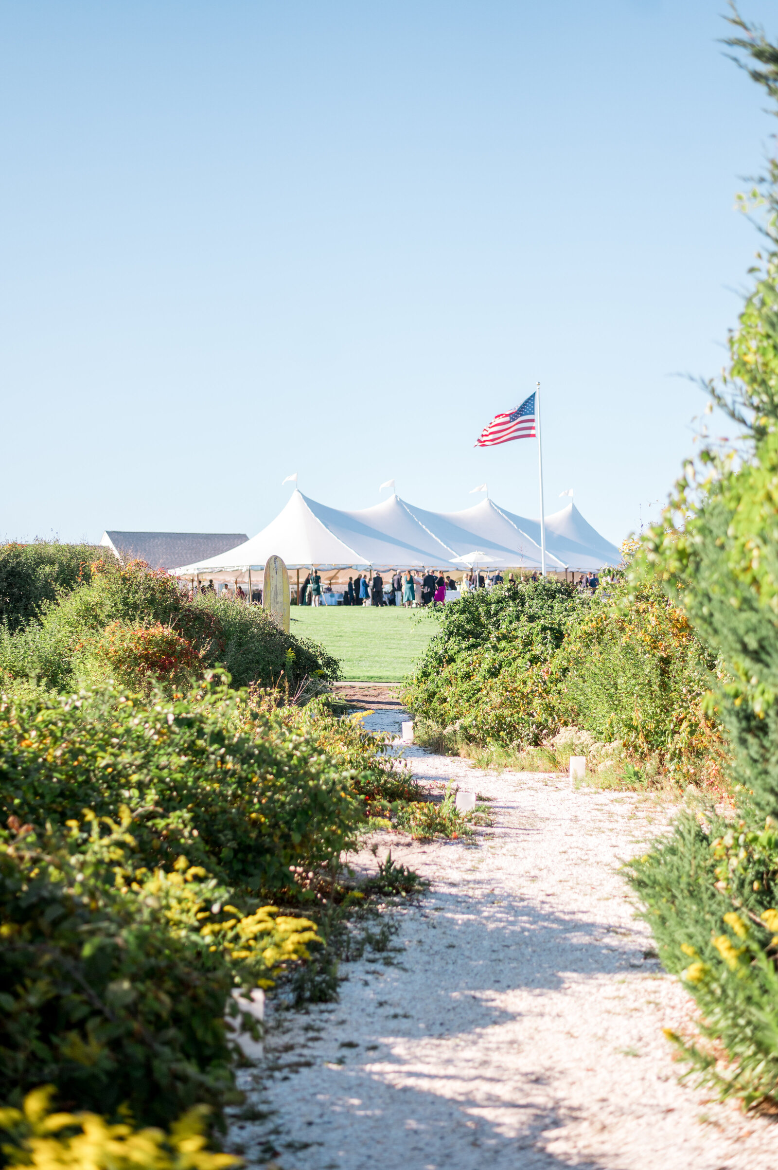 Coastal sand path leading to sailcloth wedding tent at Nauset Beach Inn on Cape Cod— airy, natural wedding photography by Sarah Surette Photography.
