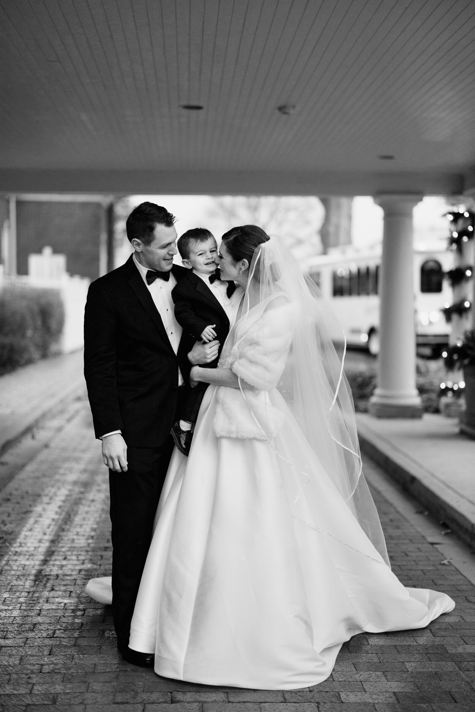bride and groom with son tux