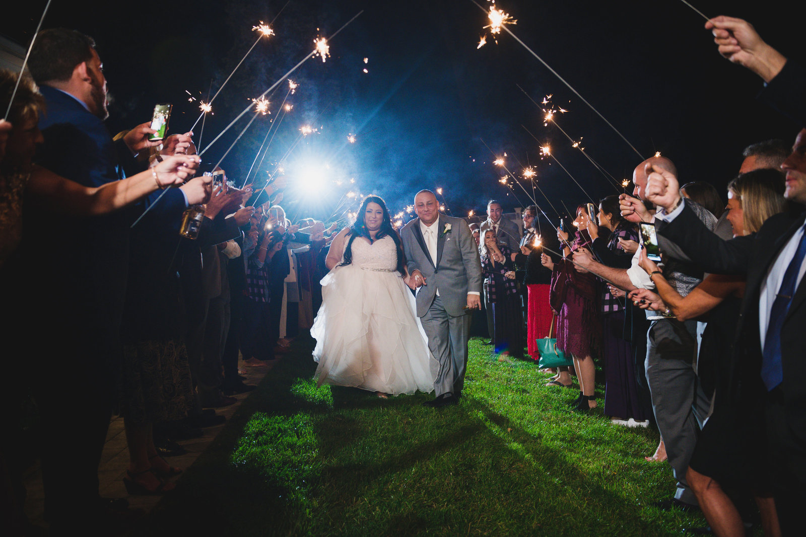 photo of bride and groom entering with sparklers from wedding at Sea Cliff Manor