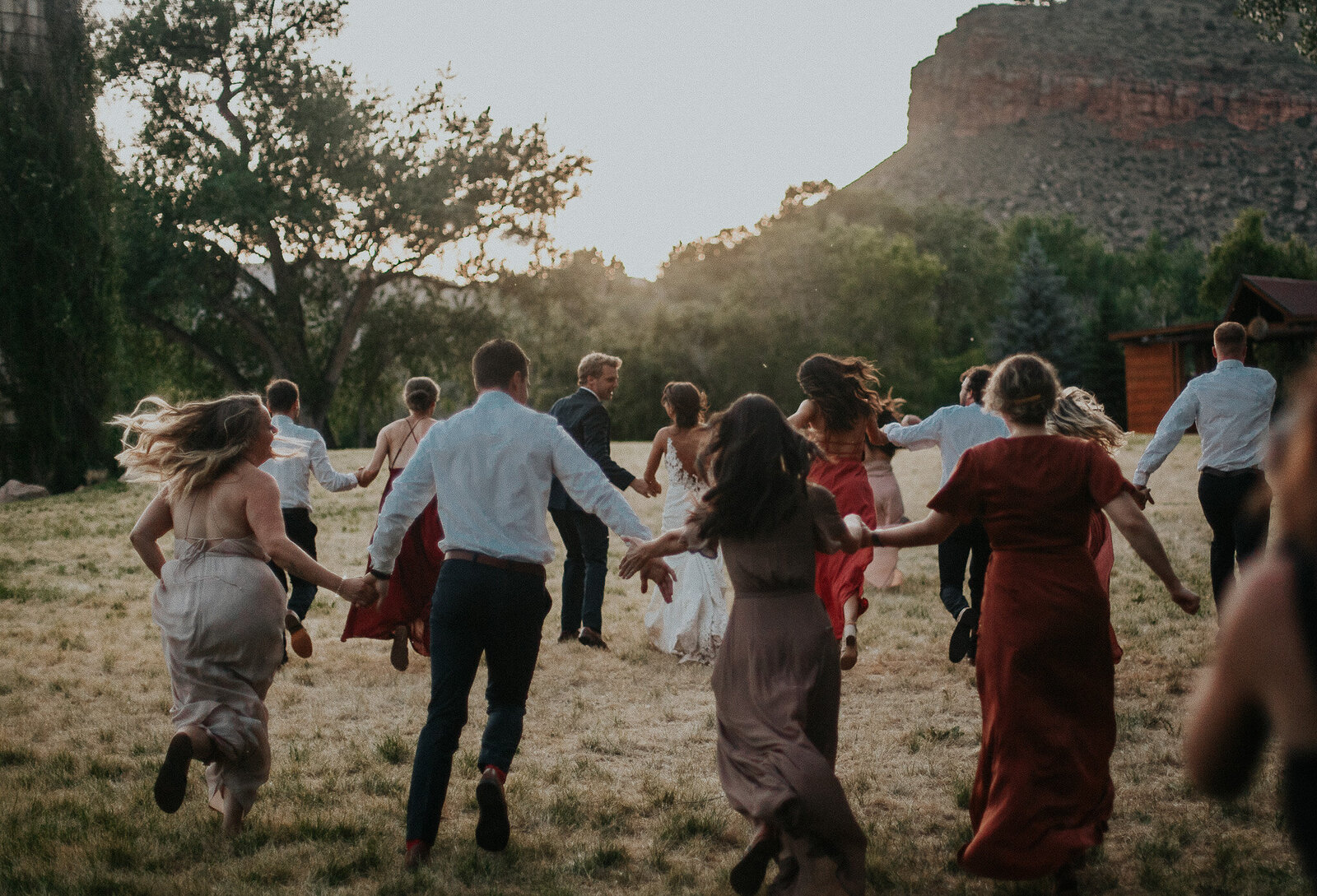 Fun photo of wedding party dancing at elopement wedding in colorado.