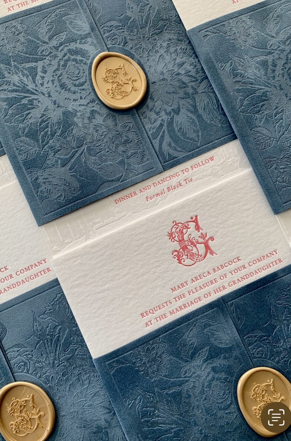 Elegant wedding invitation with custom crest design and wax seal