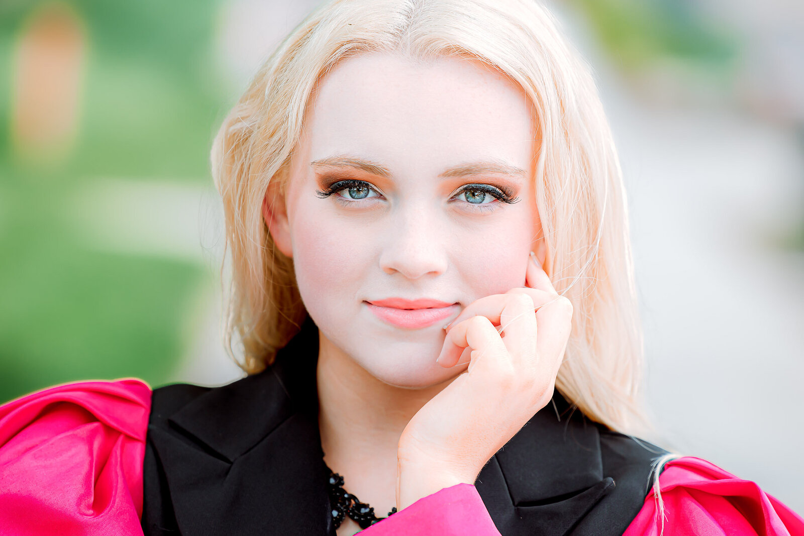 senior girl close up with hand resting on face and soft smile