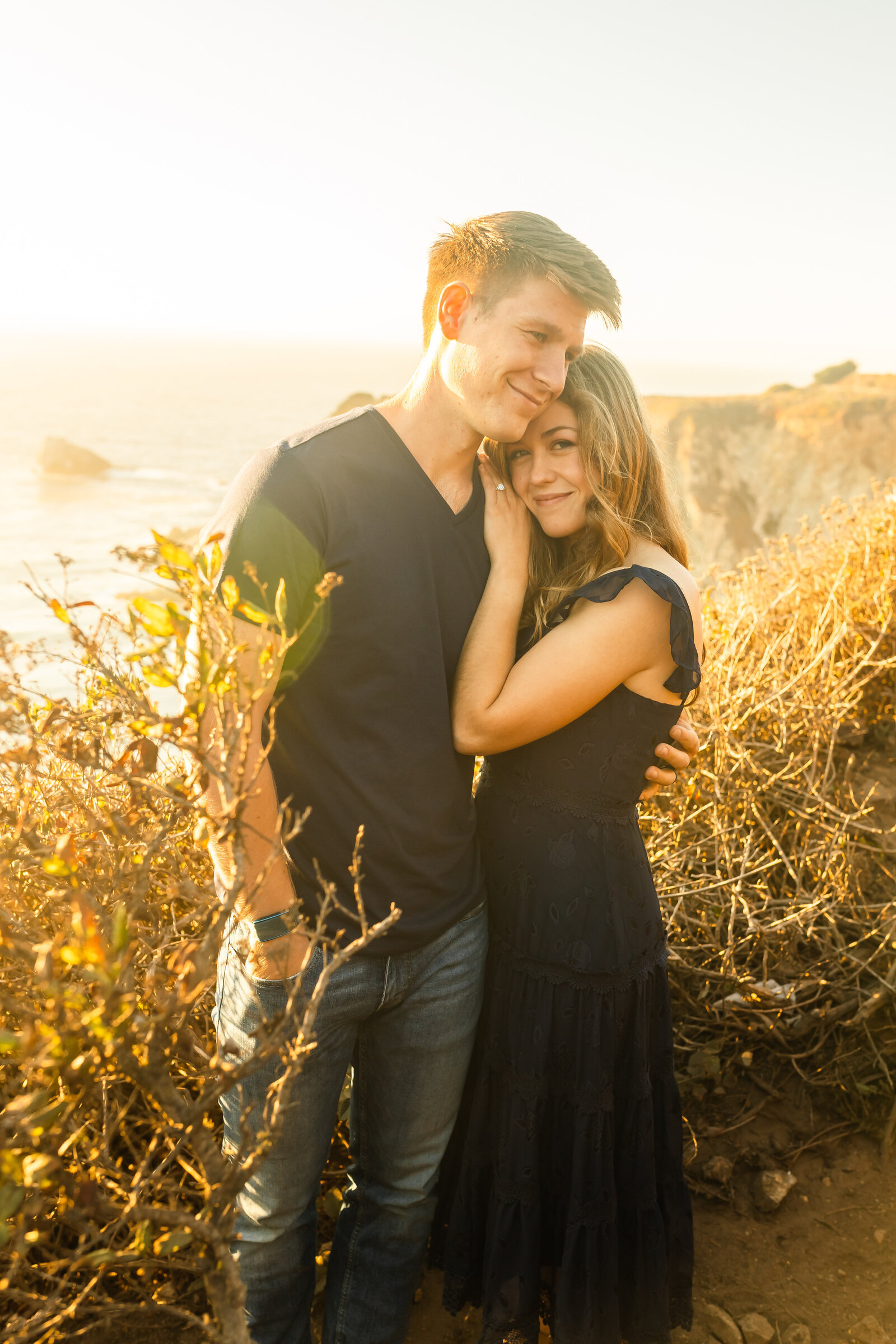 A couple poses for their engagement photos in Big Sur, California.