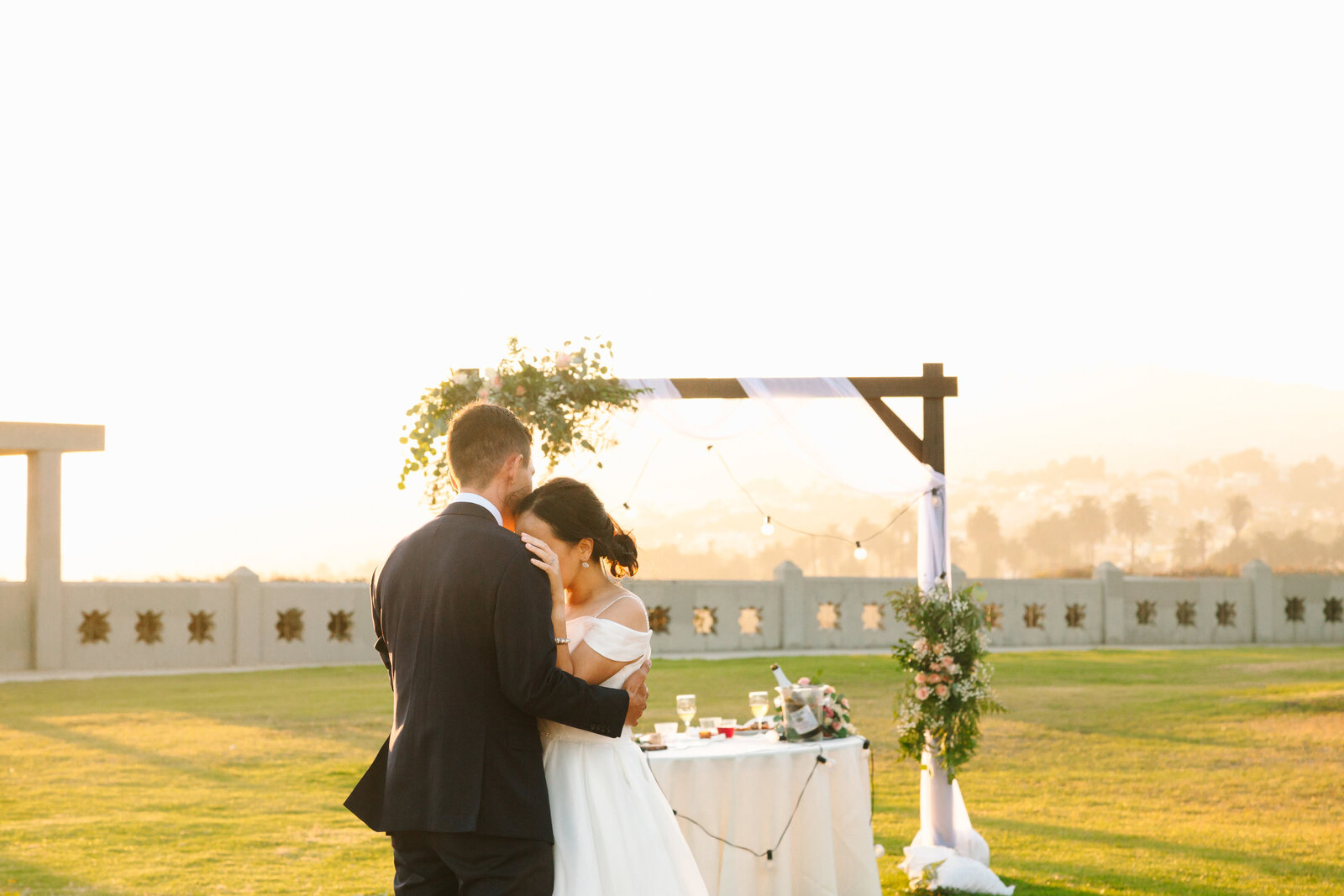 Newlyweds share their fist dance at their beach wedding in Los Angeles.