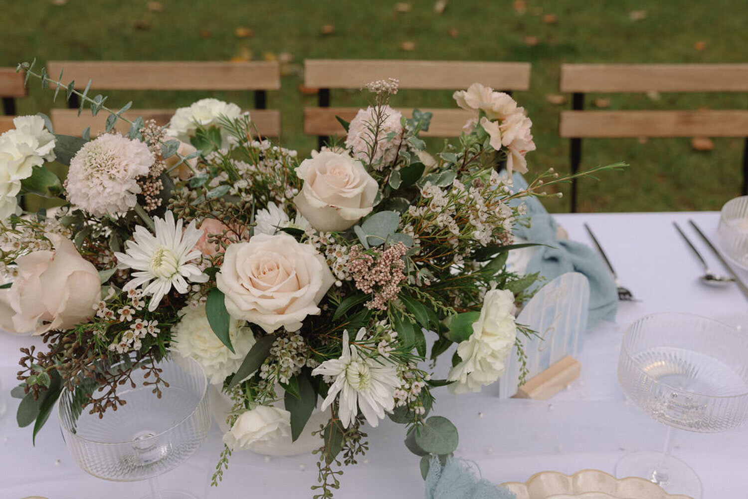 Close-up of a wedding table centerpiece with white and blush flowers