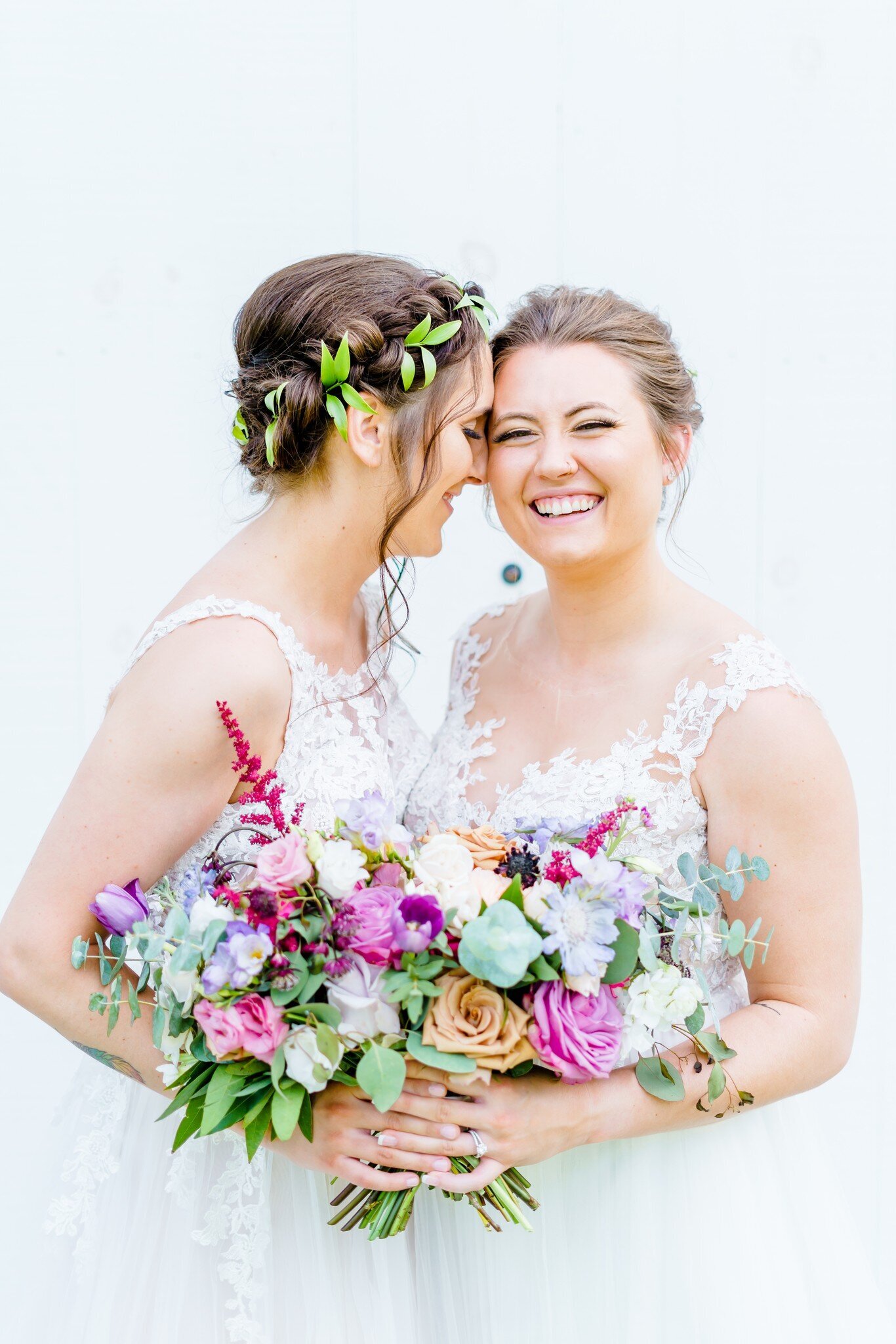 Couple smiling at Mayfair Farm Wedding Photos with Colorful Bouquets