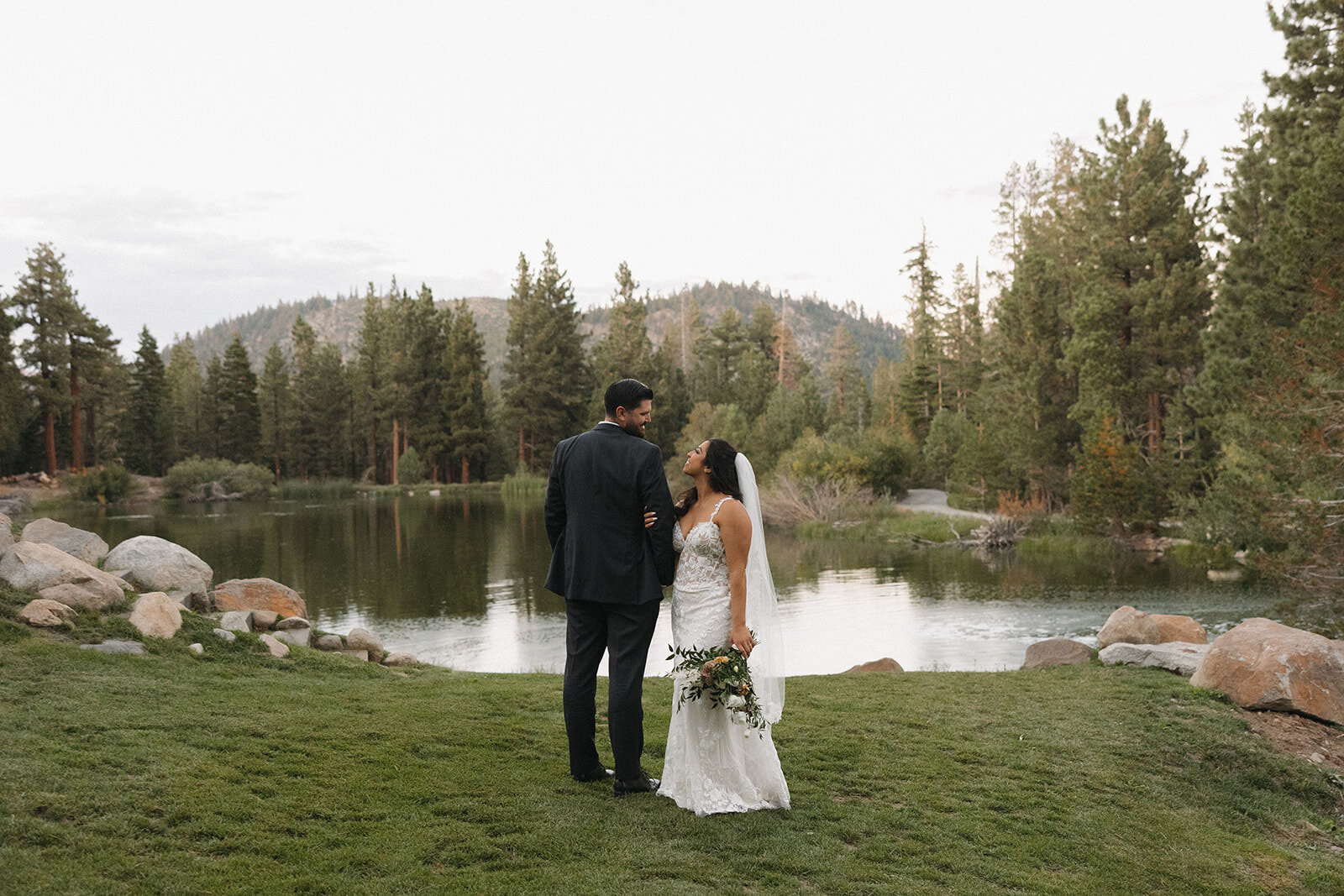 Bride and groom by a mountain lake