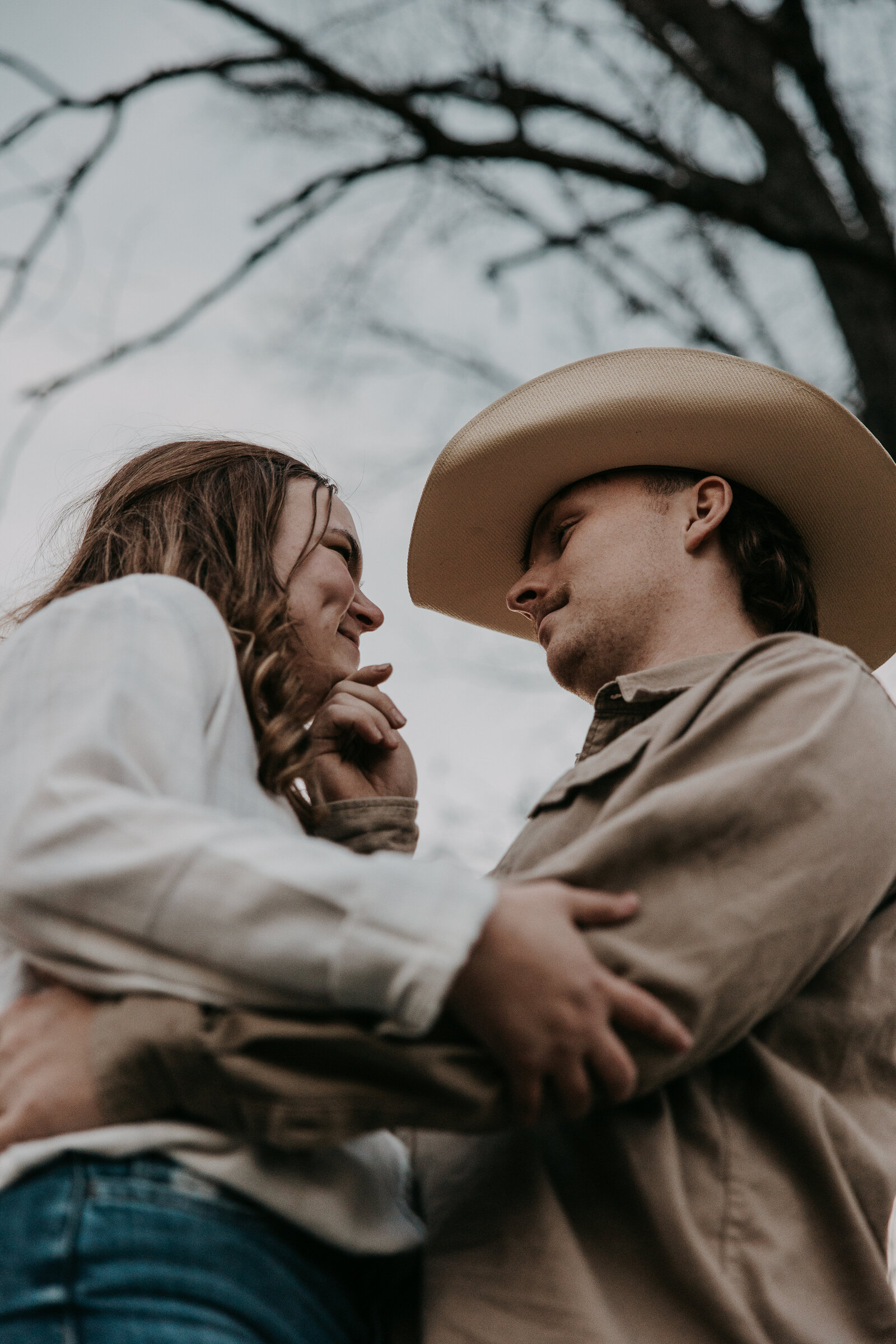 Jacob gently rests his hand on Laura's chin and looks lovingly into her eyes as the sun sets over the romantic countryside scene in West Tennessee.