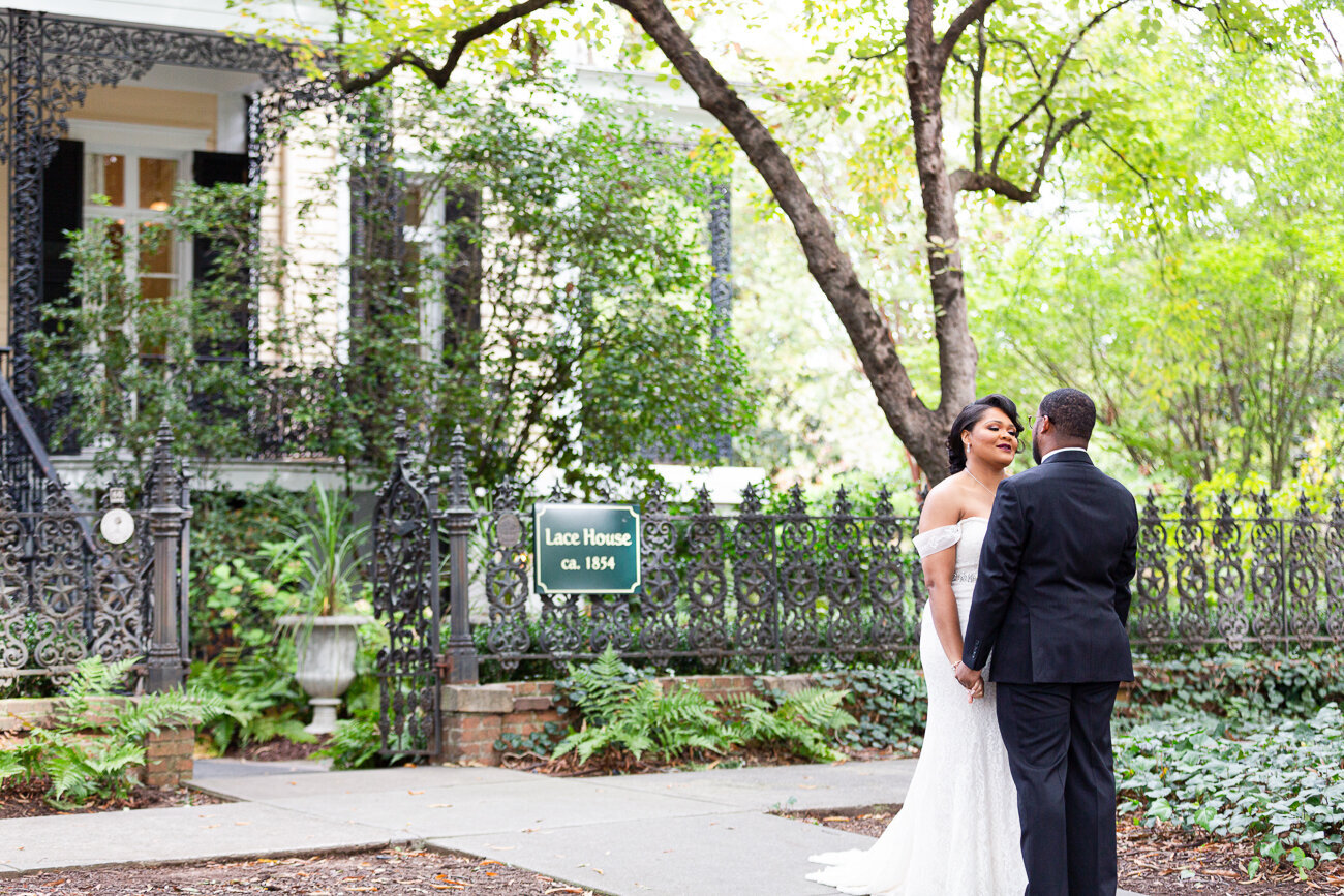 Black bride and groom holding hands at the SC Lace House