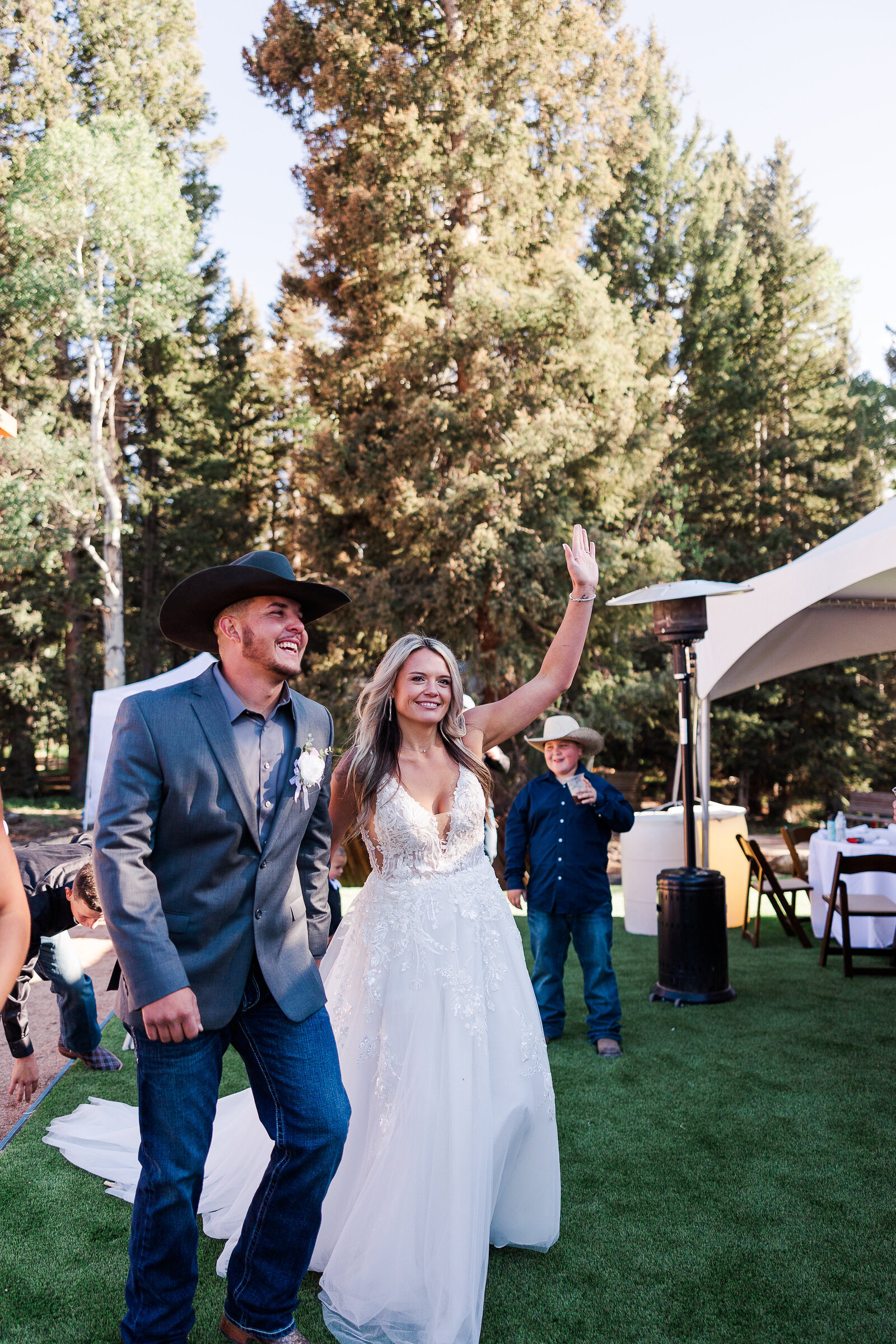Bride and groom celebrate as they walk into recpetion area at Arrowhead Lodge