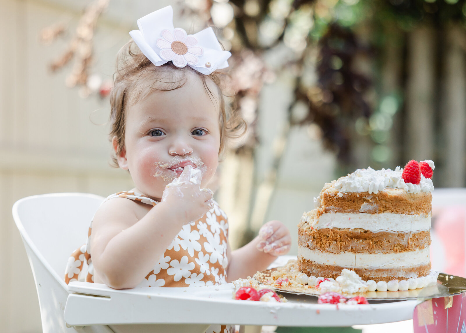 Baby's first taste of cake at a first birthday party in Union County, NJ.