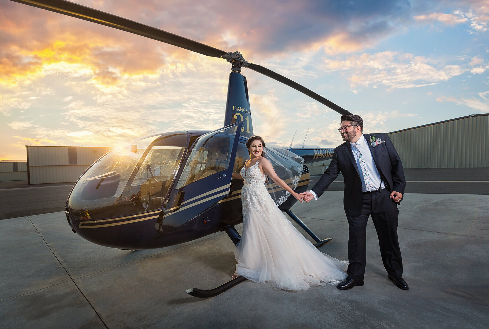 Bride and groom run to helicopter for Dallas wedding grand reception entrance at sunset