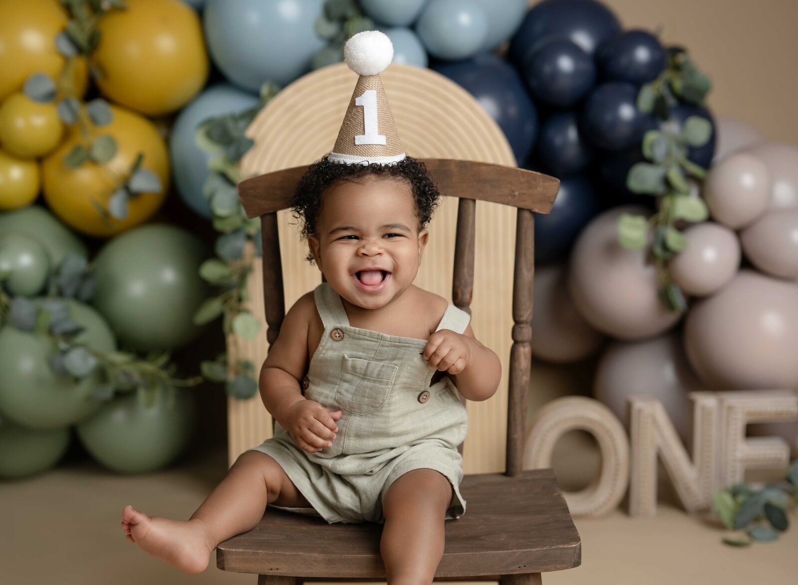 1st birthday photoshoot of baby boy laughing. Cake smash photo taken by Jenni Nikki Photography in Atlanta, GA.