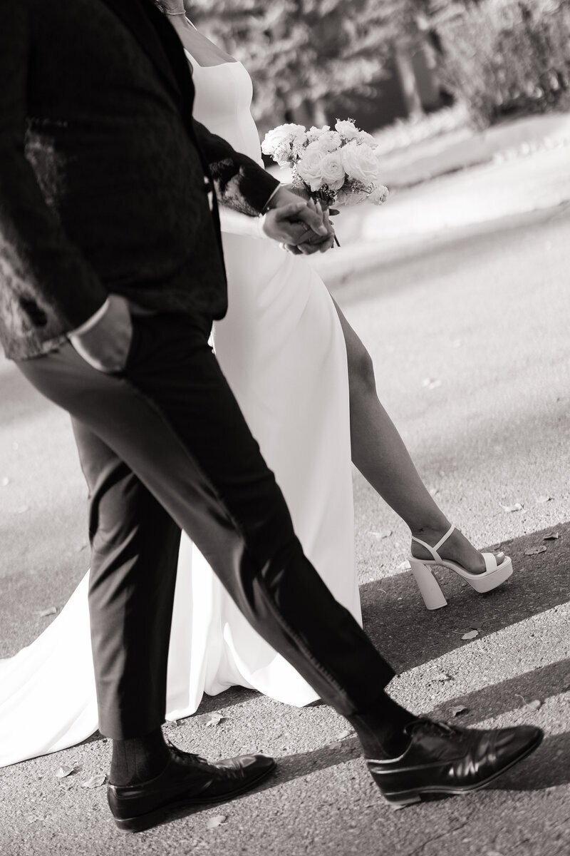 bride and groom walking across street taken by idaho wedding photographer