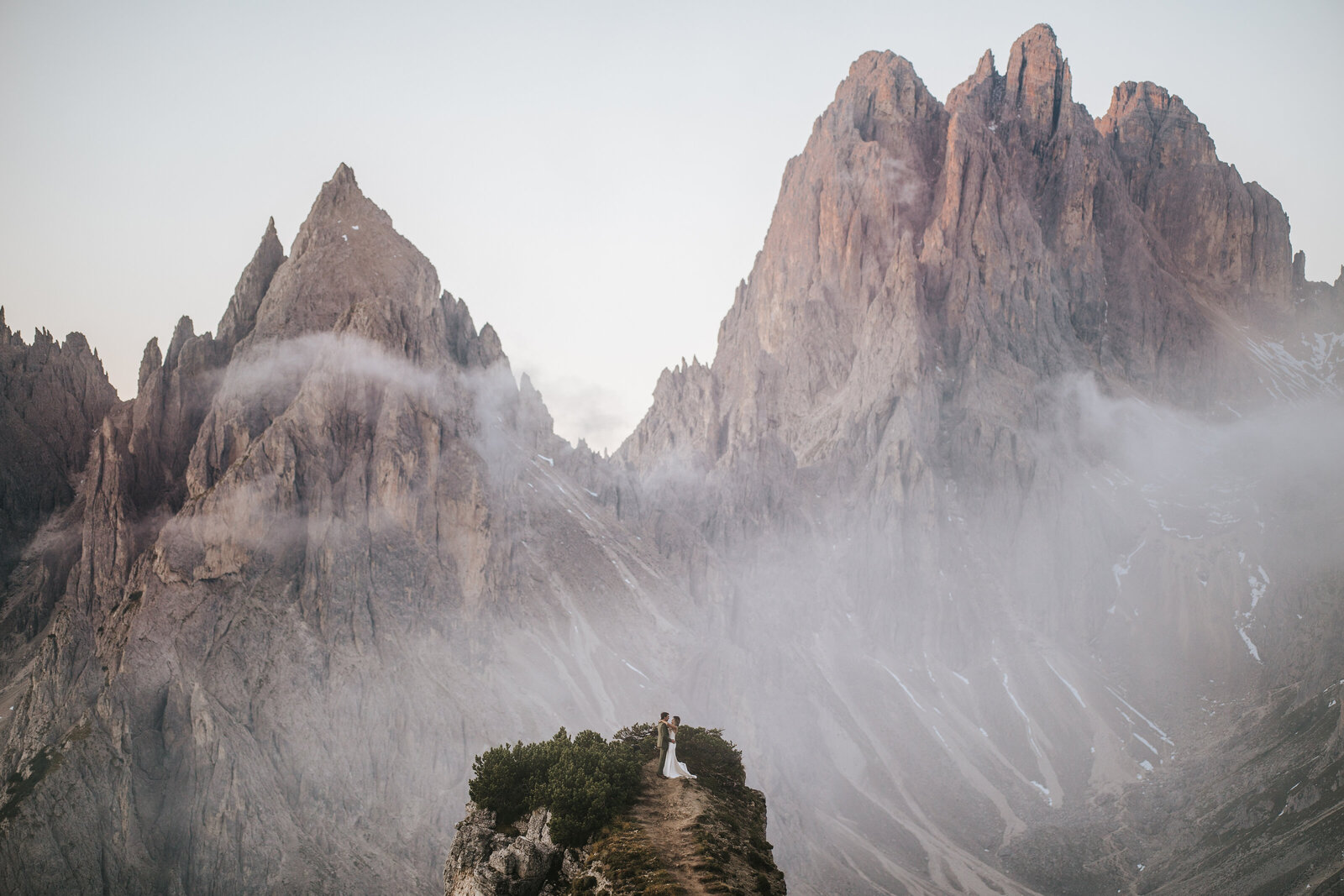 Bride and groom in a breathtaking embrace on their wedding day in the Dolomites.