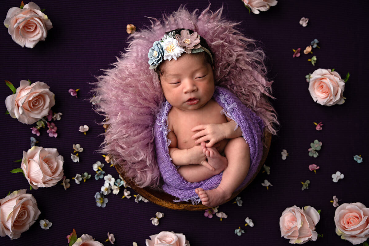 baby girl laying with flowers