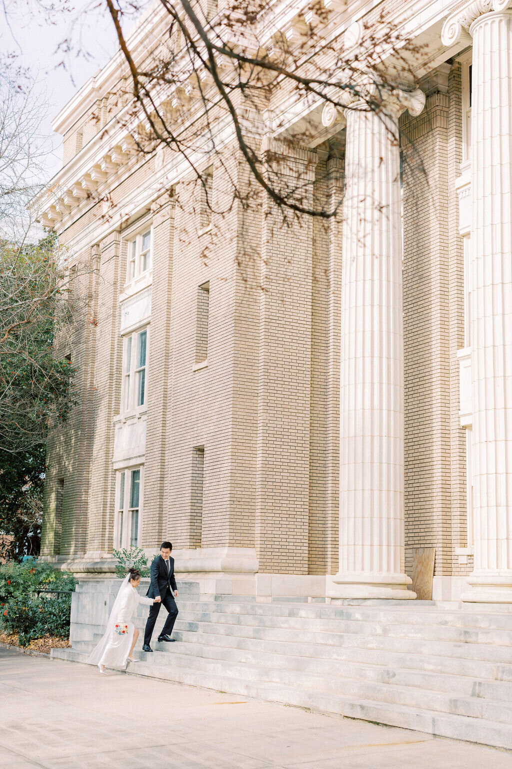 Couple walks up the steps of the Courthouse in Athens, Georgia