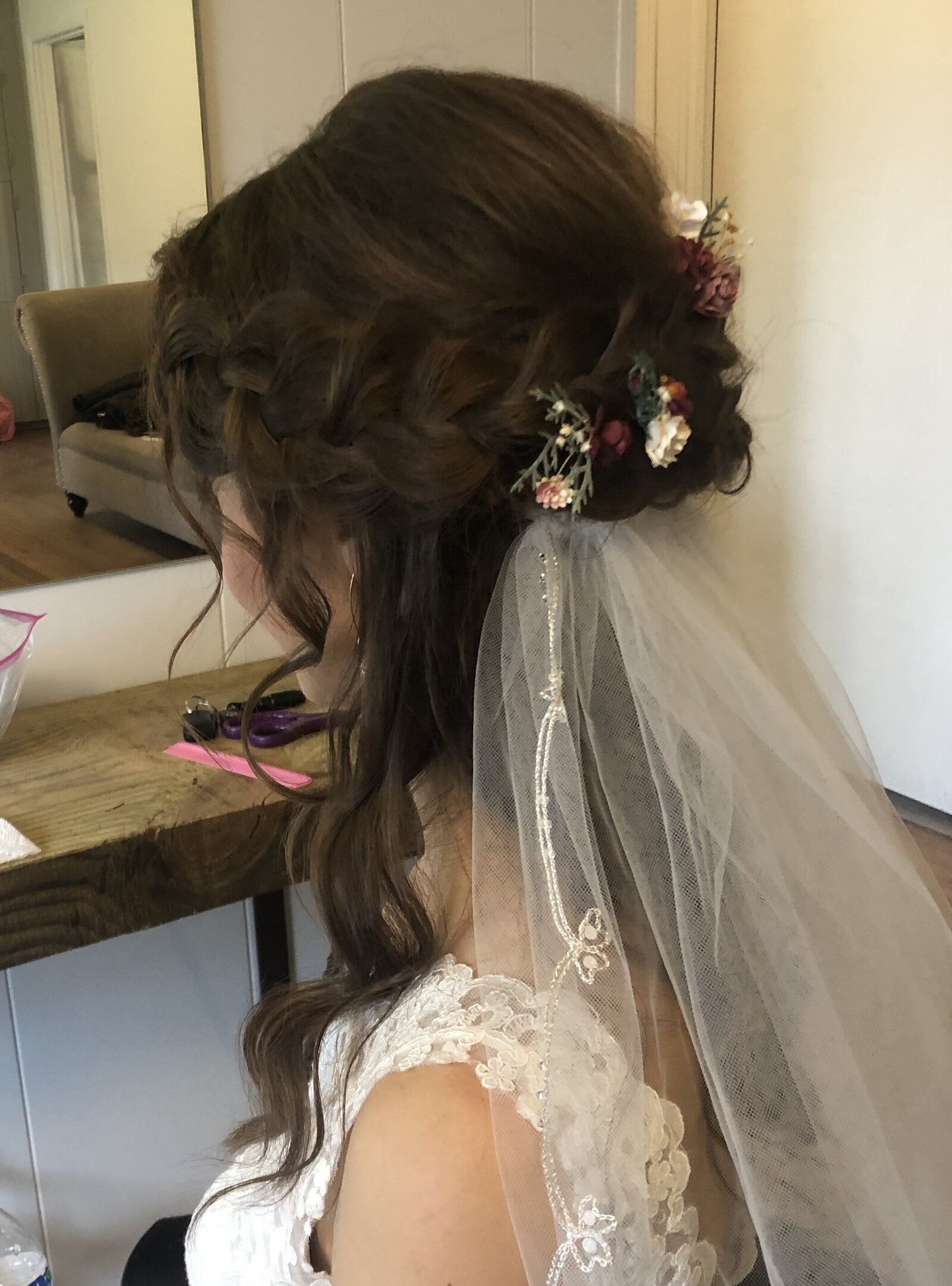 Romantic bridal hair big braid with flowers and low veil Bridal hair stylist Kansas City