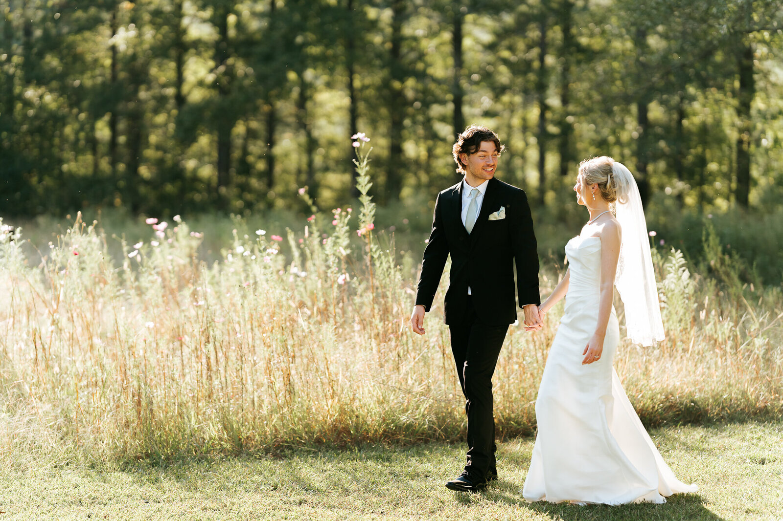 bride and groom going for a stroll at the lake after the ceremony at Daisy hill in South Georgia