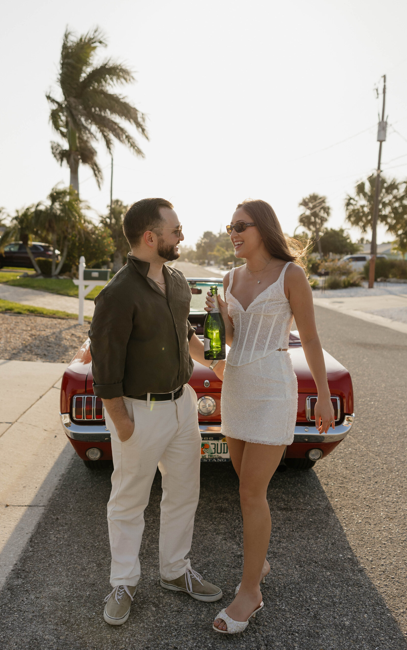 A couple laughing together during an engagement session in Florida.