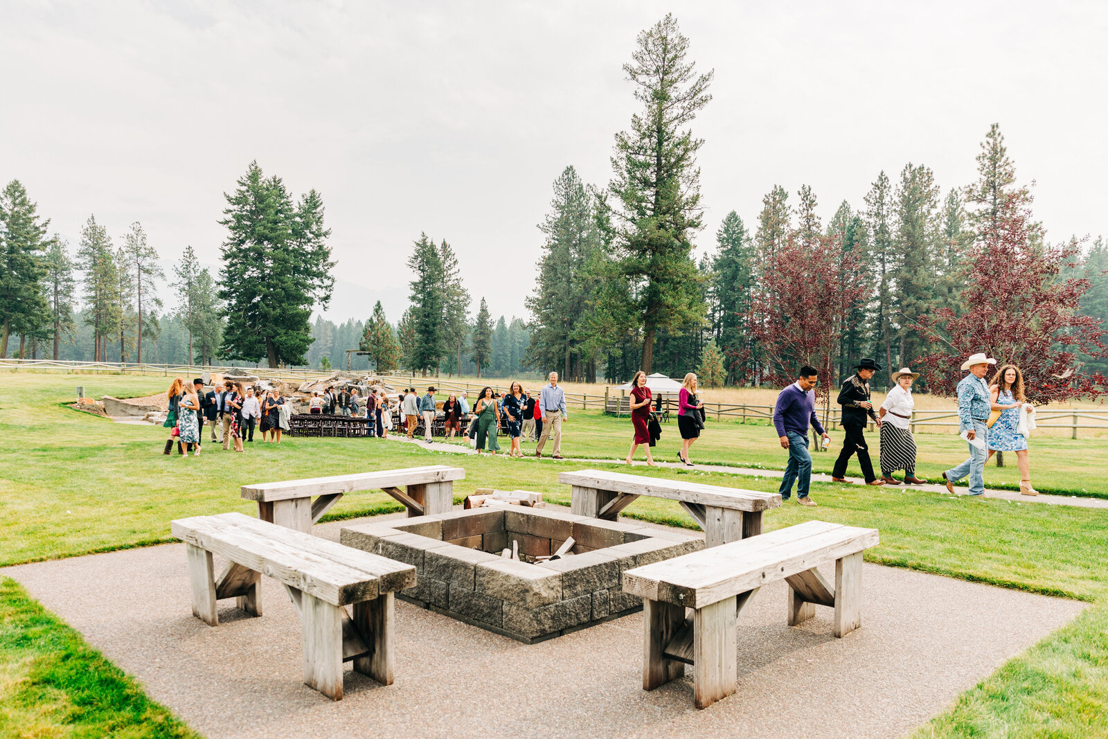 Wedding guests walking near fire pit at The Silver Knot in Ronan, MT