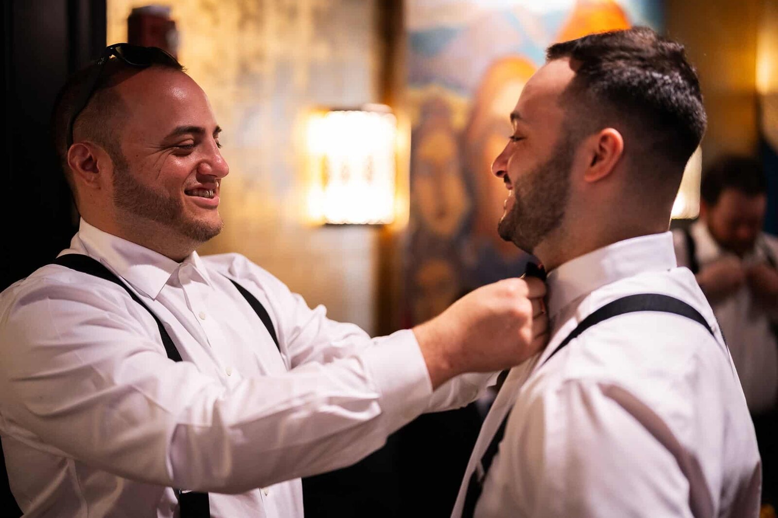 groom getting ready for his wedding at Casa Monica with help of the best man