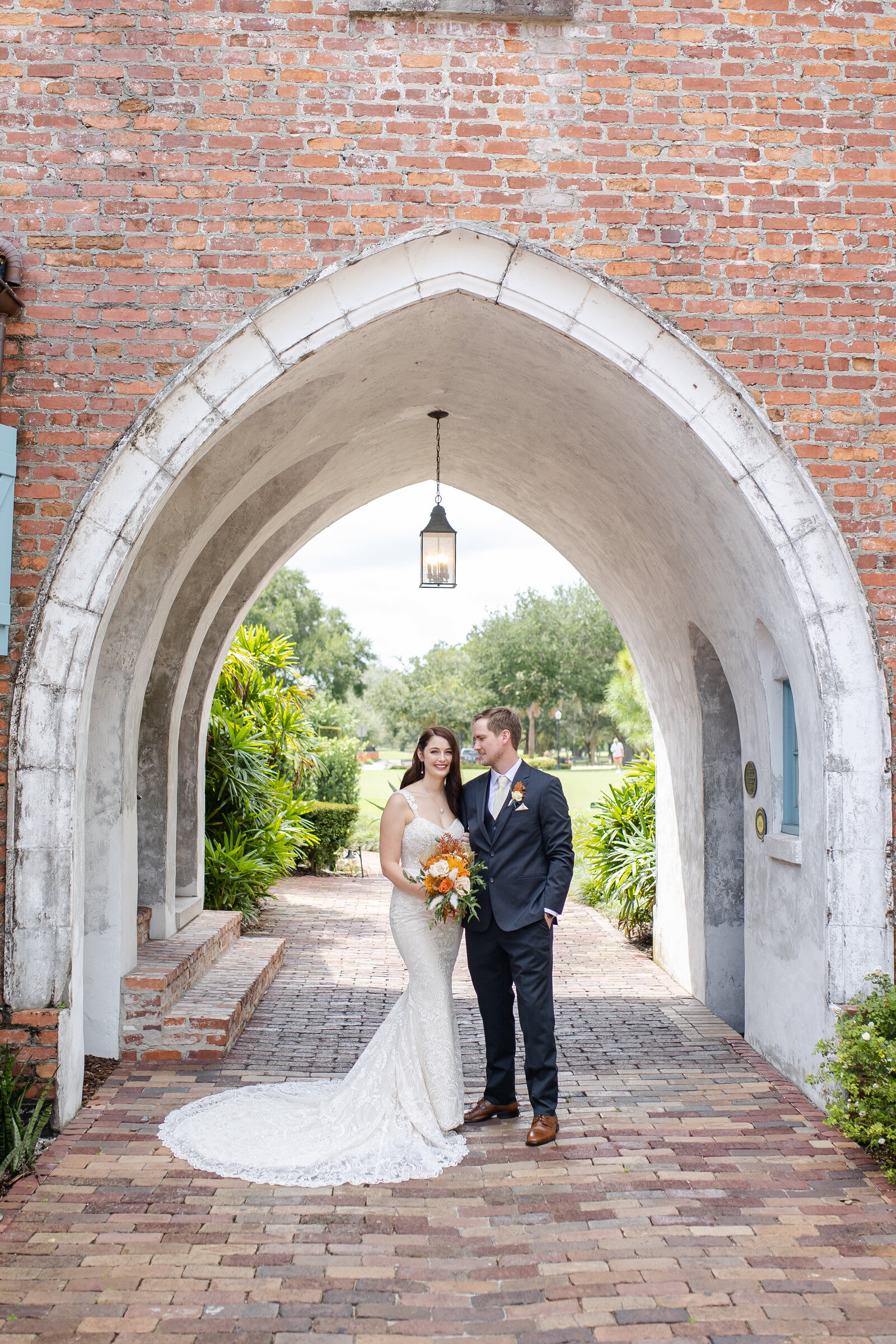 Wedding couple under arch Riley James Photography