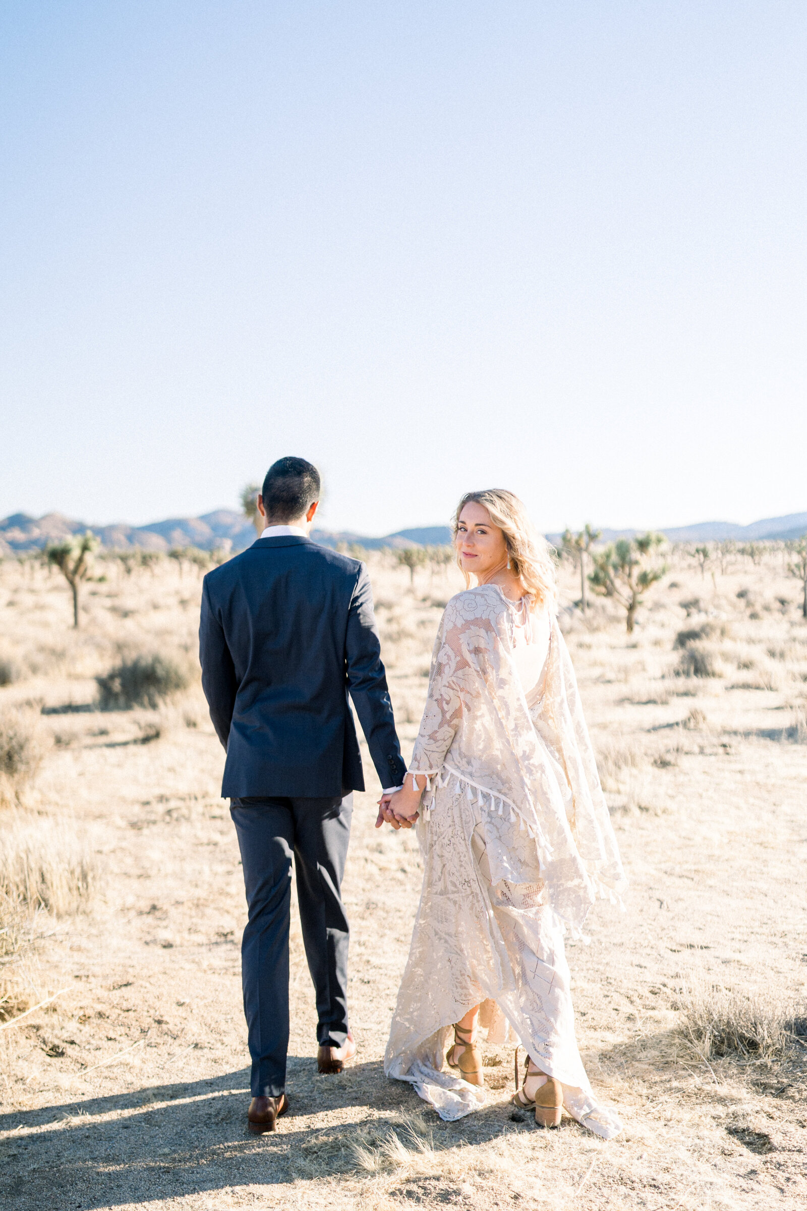 Bride and groom walking away at their Joshua Tree Elopement in California