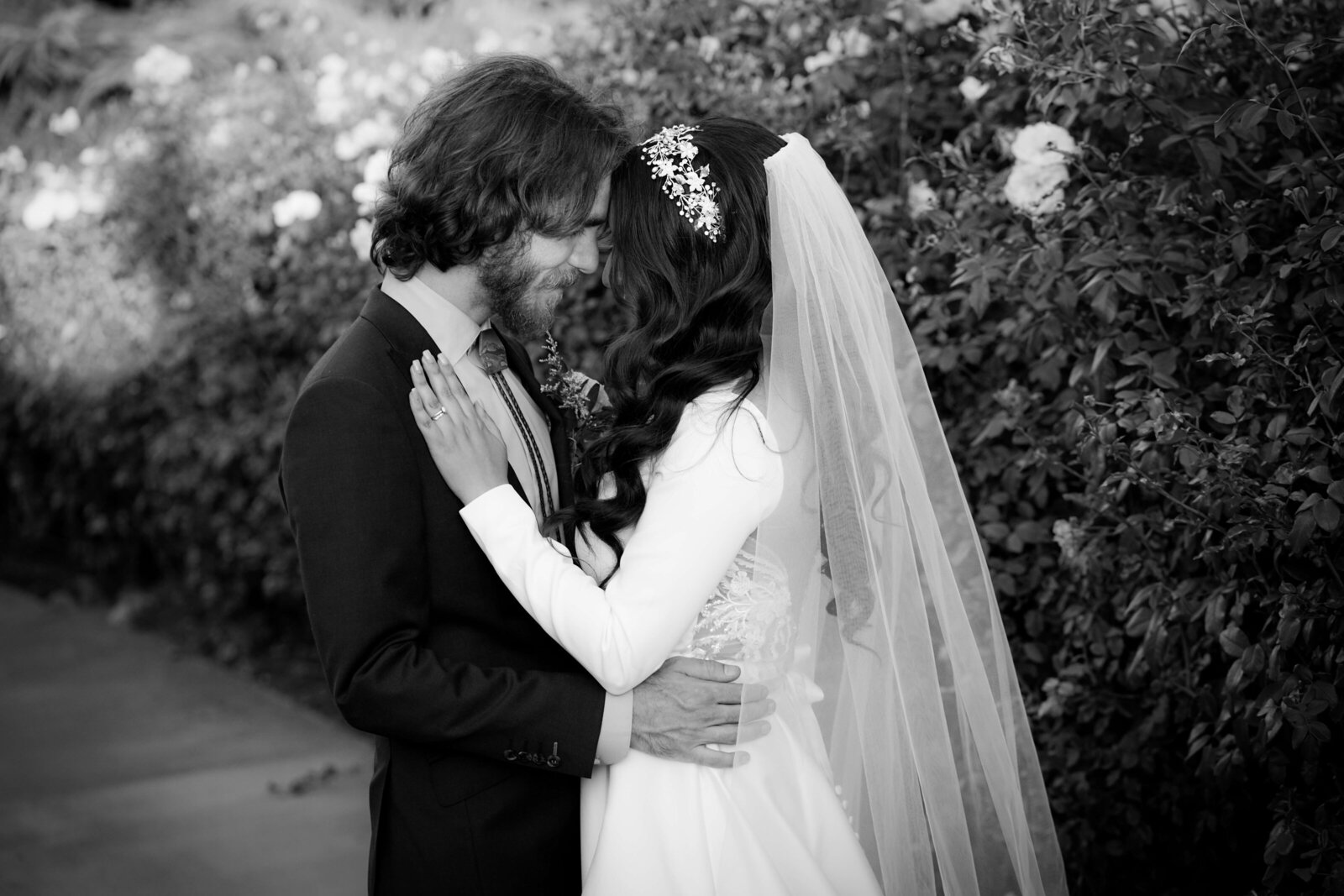 KS Gray Photography Newport Beach Bride and groom in front of bushes black and white photo