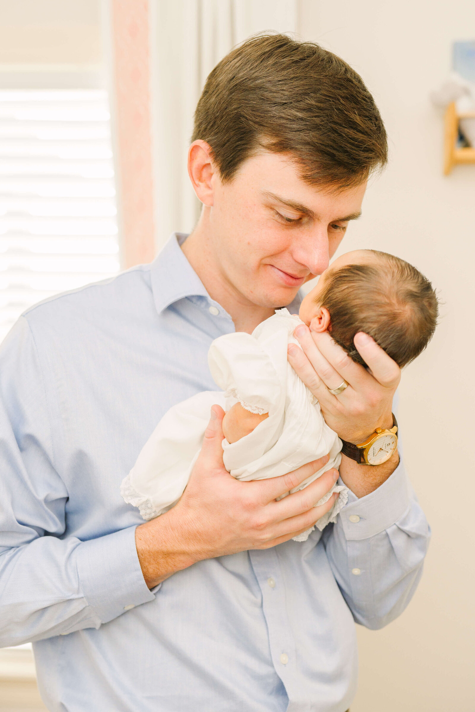 Dad holding baby nose to nose