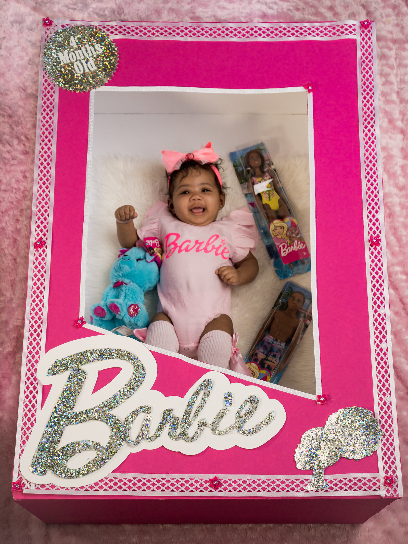 baby in barbie box with toy barbie and kin