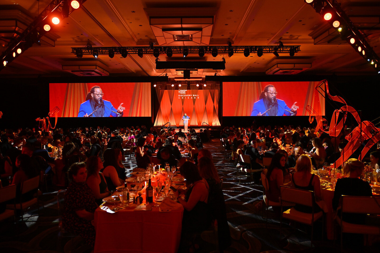 Speaker on stage at a formal dinner event