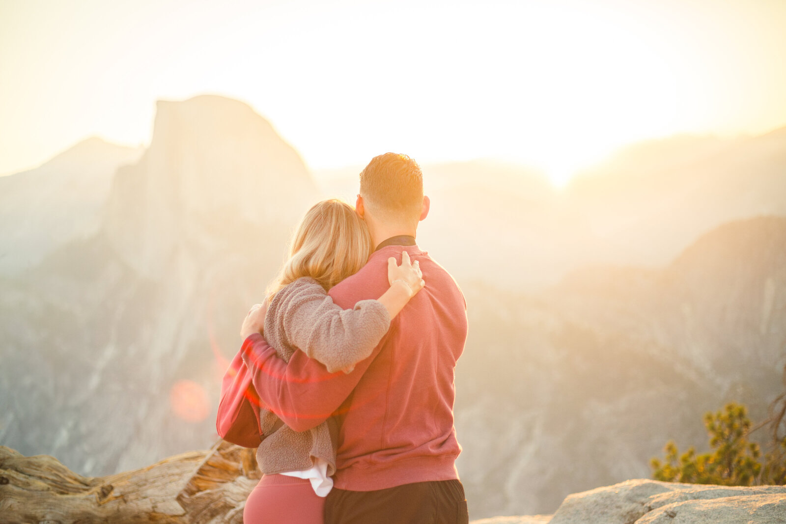 A wedding proposal between two hikers at sunrise in front of Half Dome in Yosemite National Park.