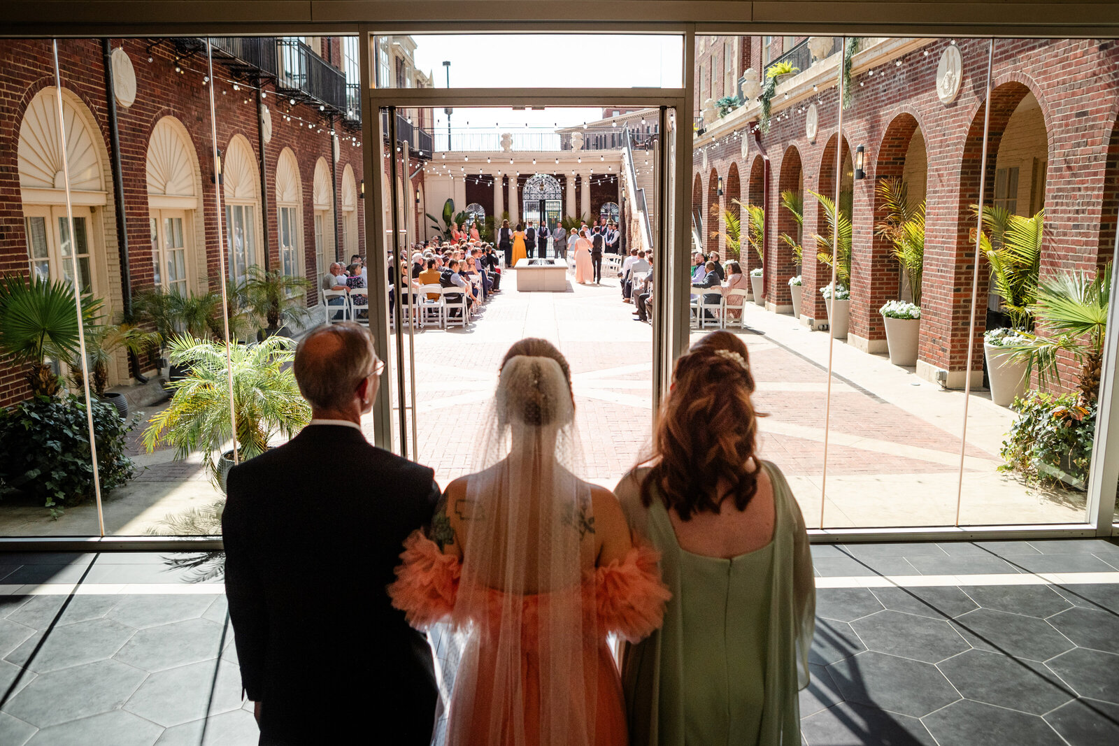 Partens of bride walking bride down the isle