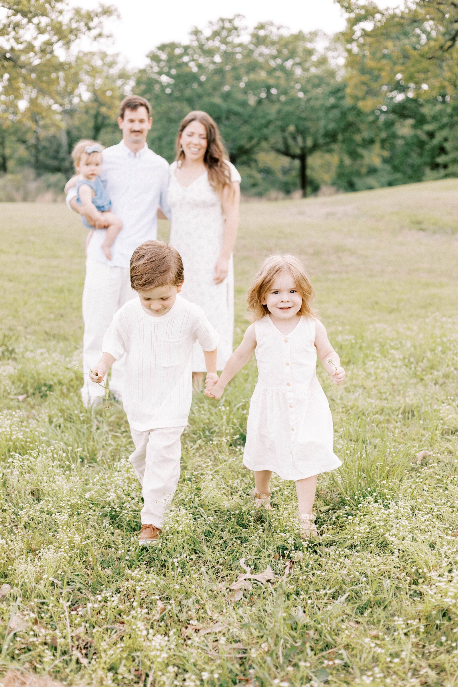 brother and sister holding hands while walking during peoria illinois family photos 