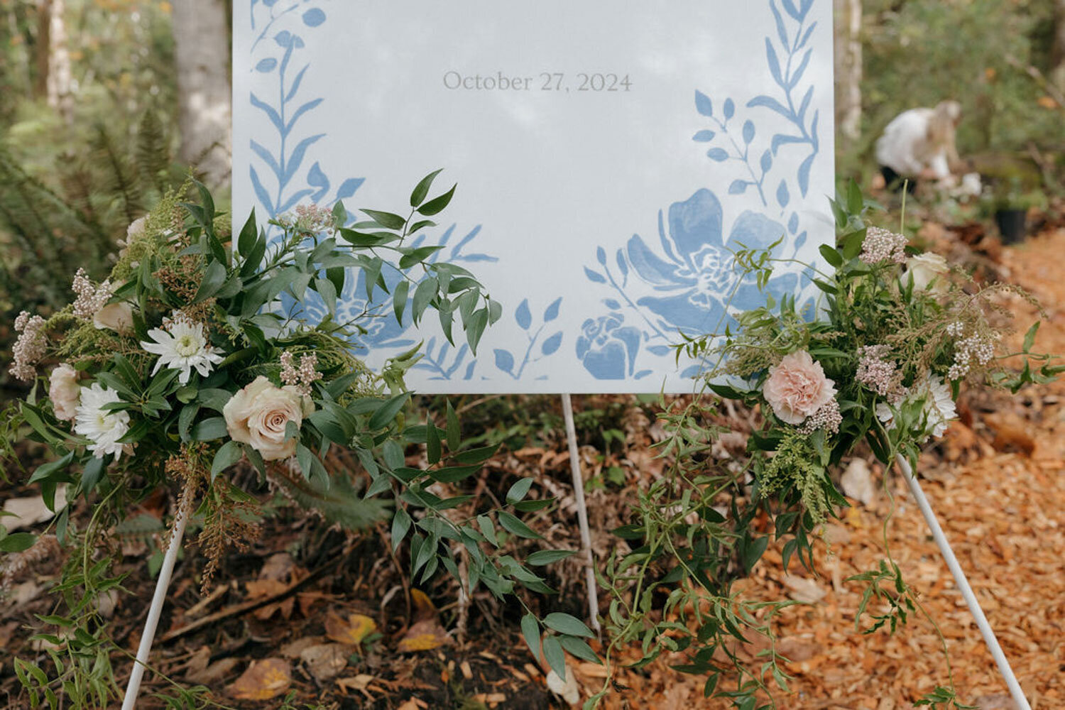 elegant wedding welcome sign surrounded by florals