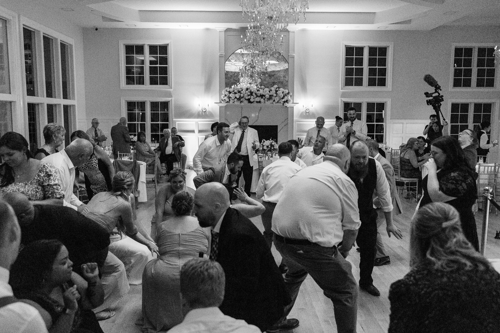 Candid black and white shots of guests dancing at SkyView Golf Club reception