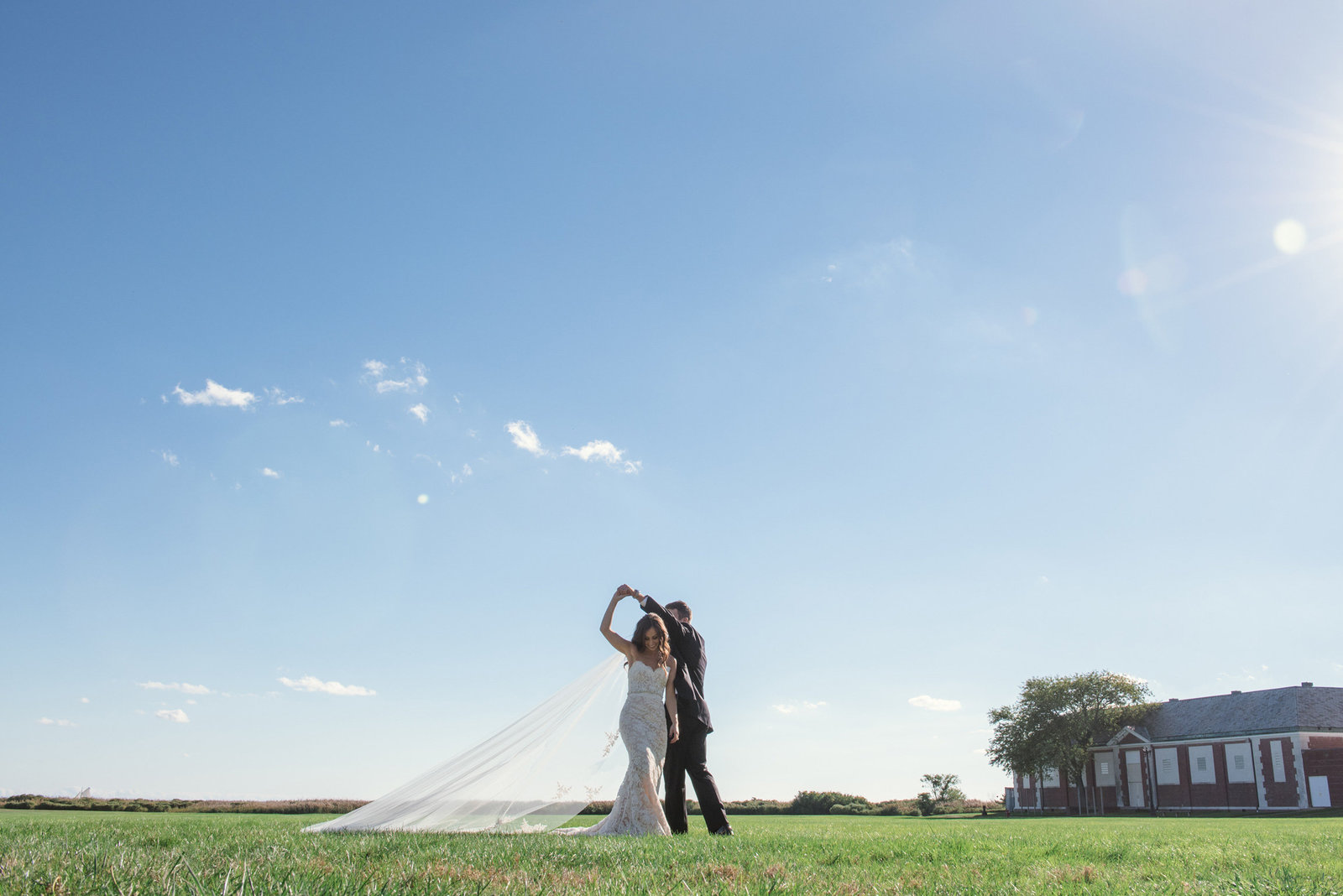 Bride and groom on the field of the Bourne Mansion