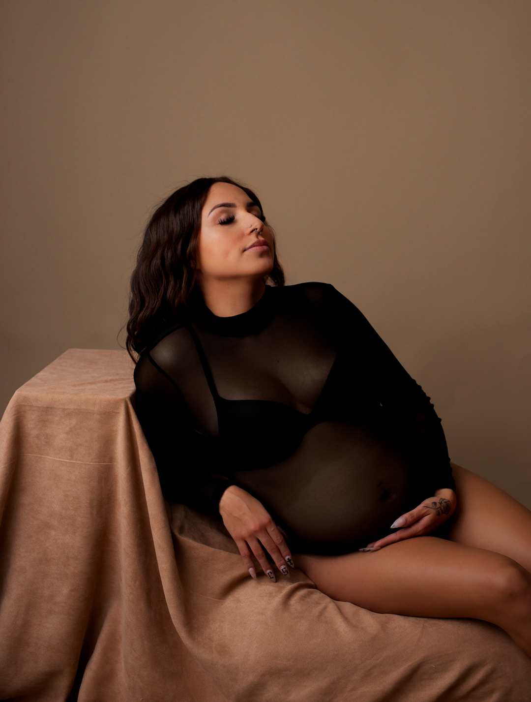 Maryland Maternity Photographer - Snapzbytie Photography - Mom sitting on couch in mesh bodysuit