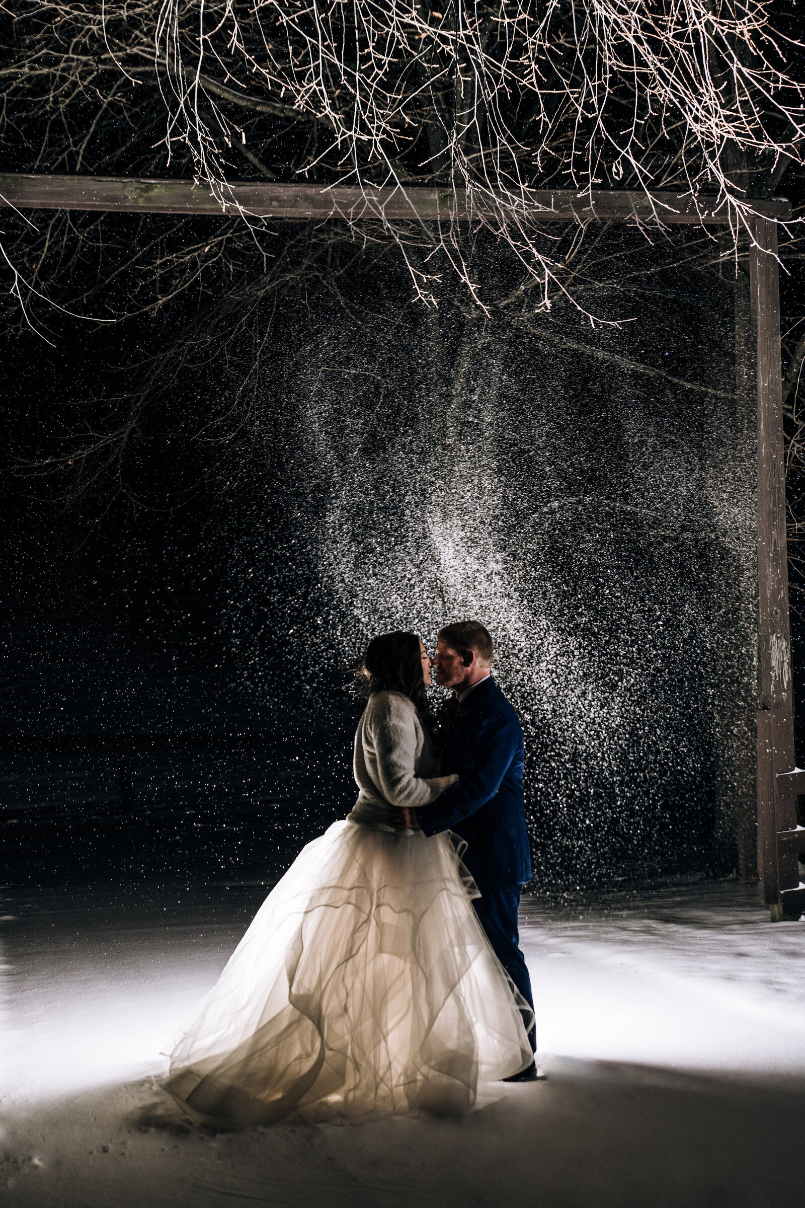 Snowy wedding photo at night at  a barn in Ohio