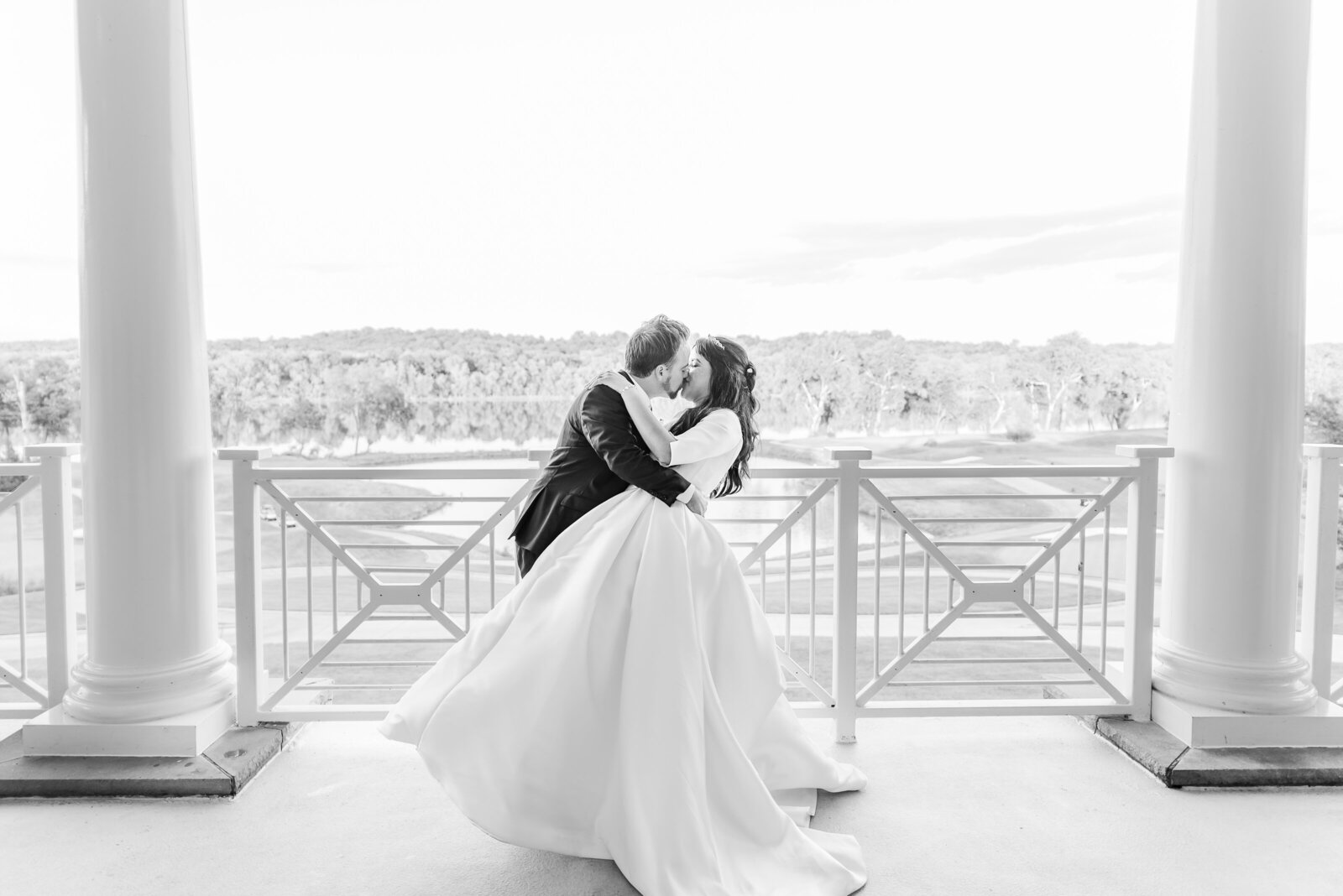 grom dipping bride in epic kiss balcony of river creek country club